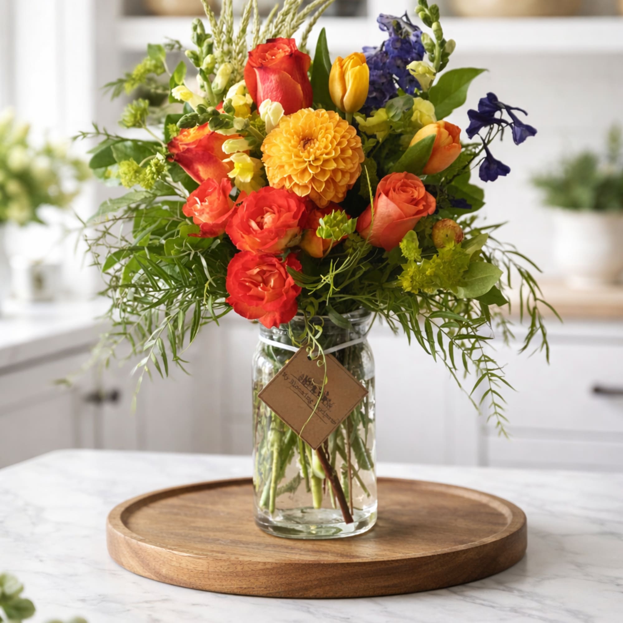 Colorful mixed bouquet in a clear glass jar vase
