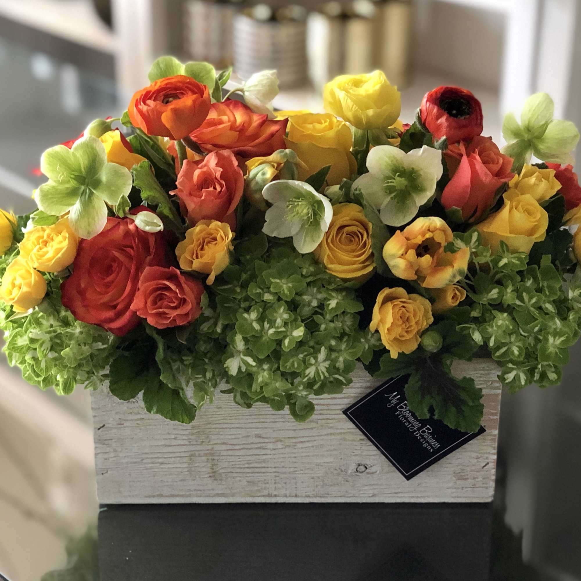 Mixed roses and hydrangeas in a rustic wooden box
