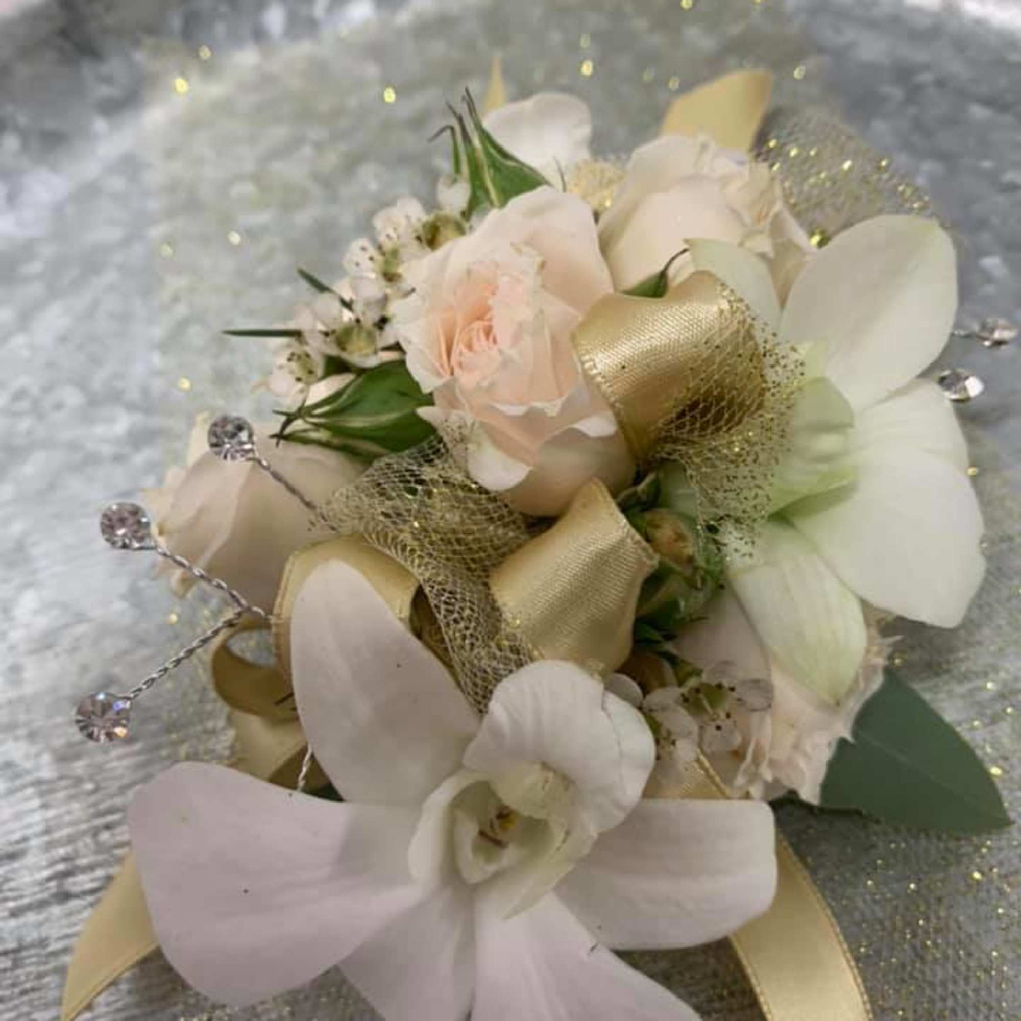 Small cream and blush floral corsage with gold ribbon and rhinestone accents