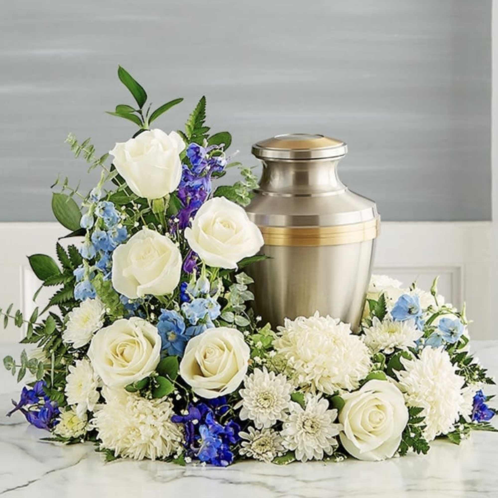 Let this beautiful low wreath of white and light blue flowers gently