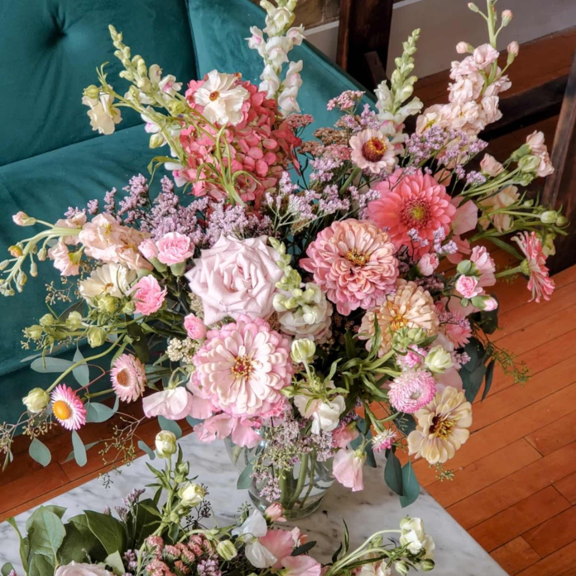 Large pastel flower arrangement in a clear glass vase