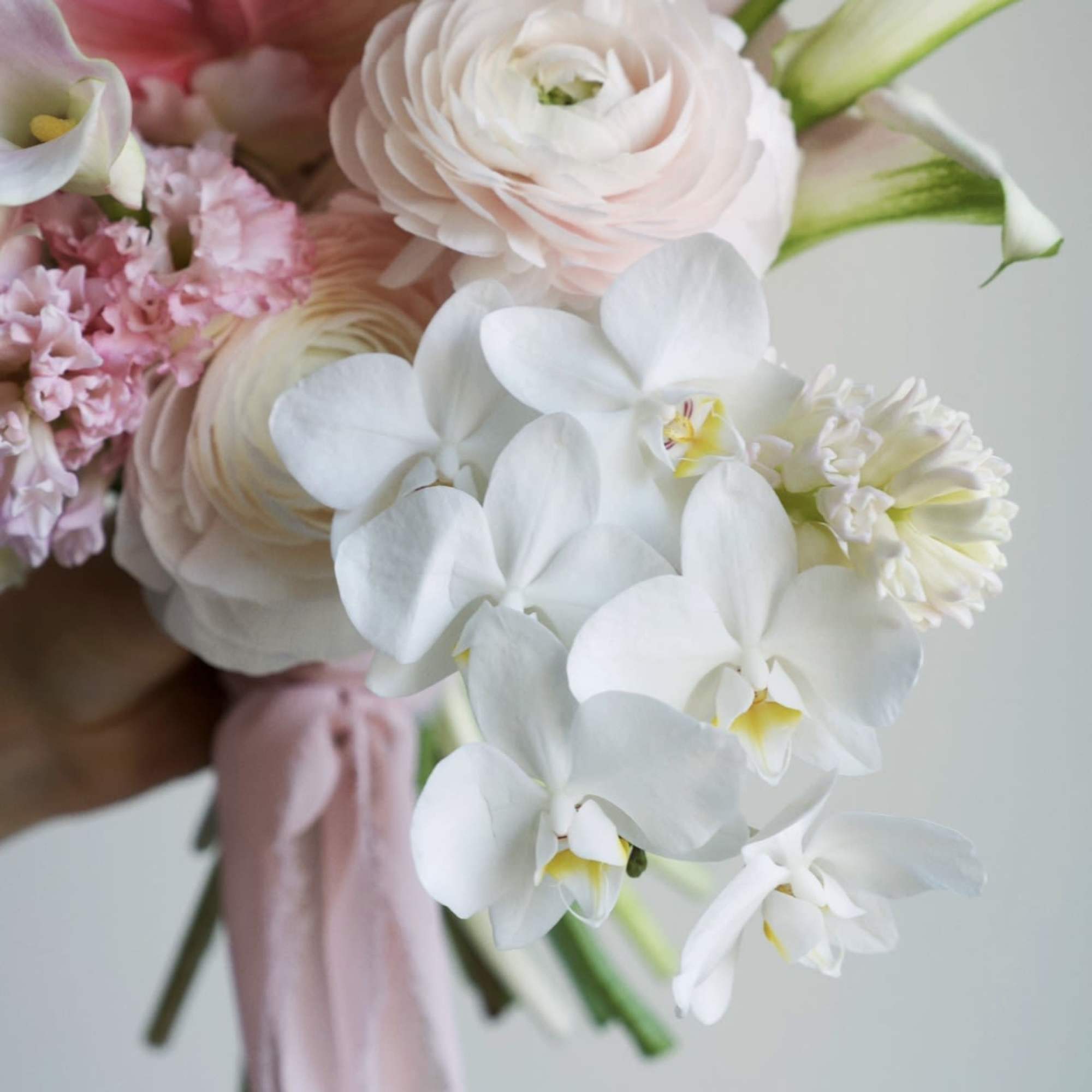 A dreamy bridal bouquet in soft blush and ivory tones, capturing the