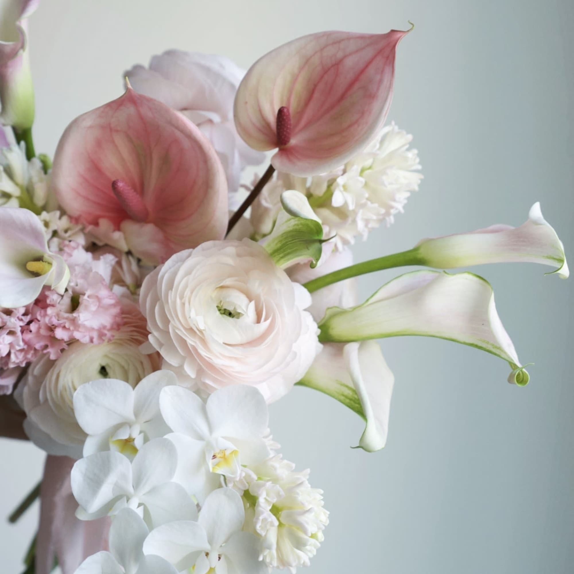 A dreamy bridal bouquet in soft blush and ivory tones, capturing the