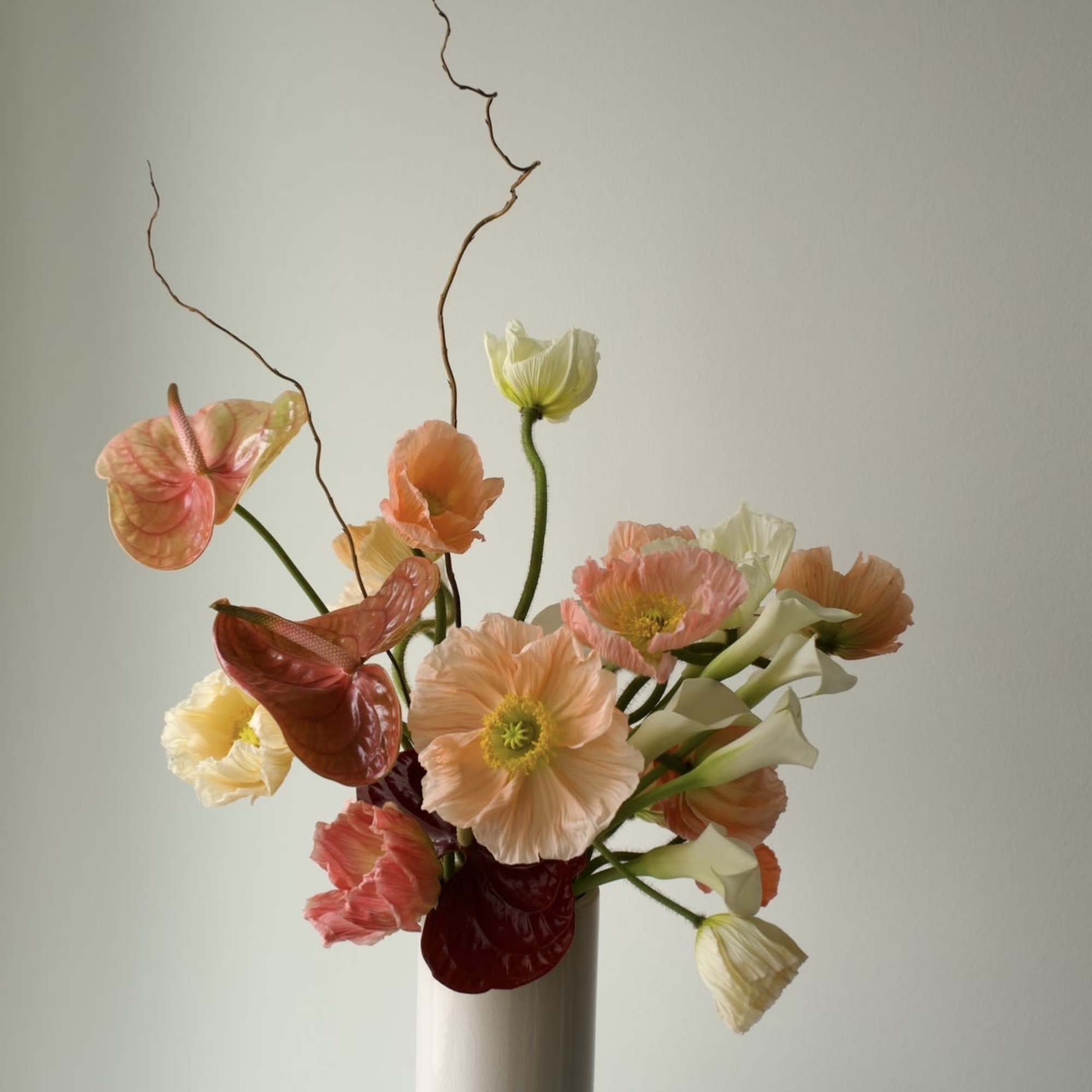 An airy, sculptural spring arrangement with a refined, modern feel. 
Featuring poppies
