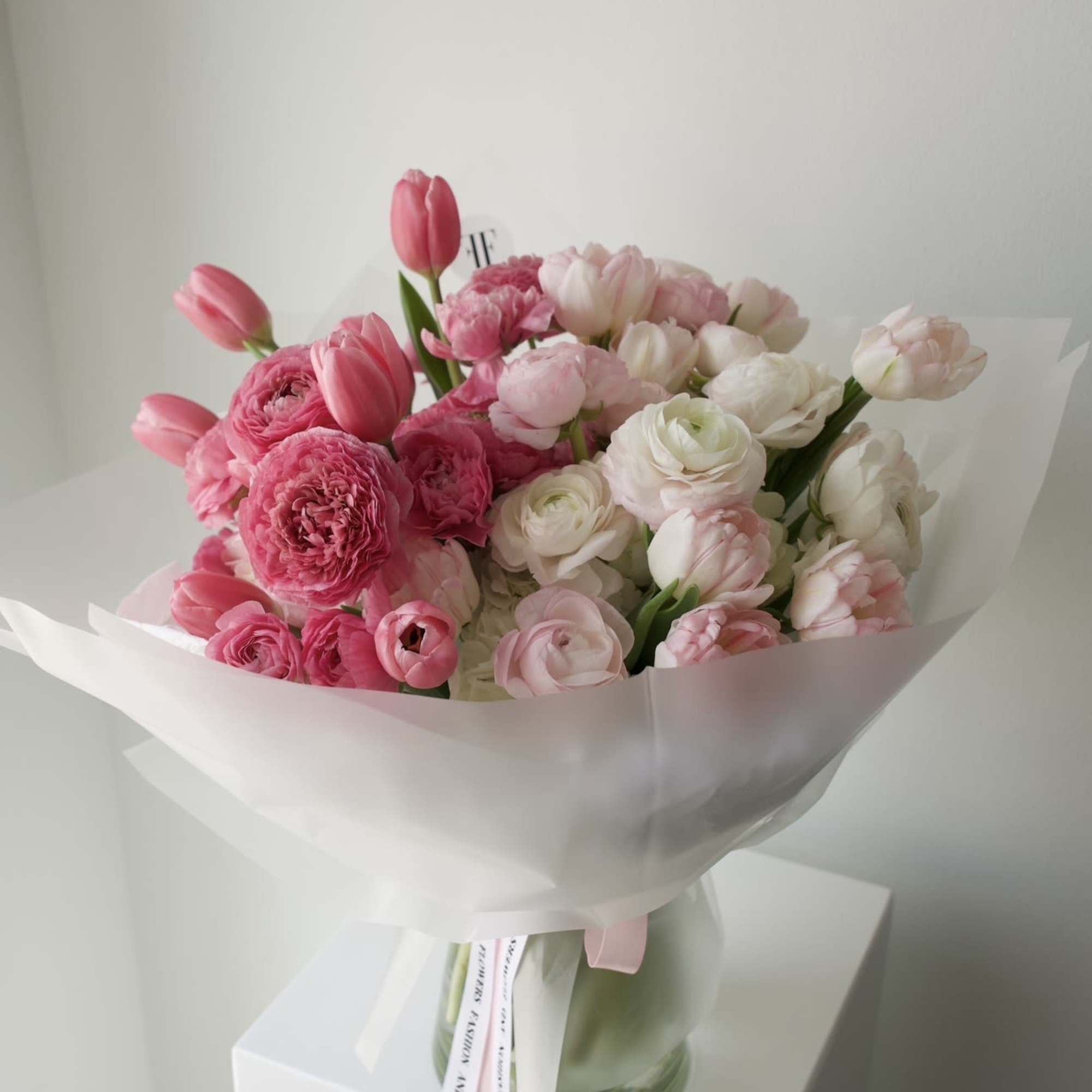 A soft, cloud-like bouquet in layered shades of pink and ivory. 
Filled