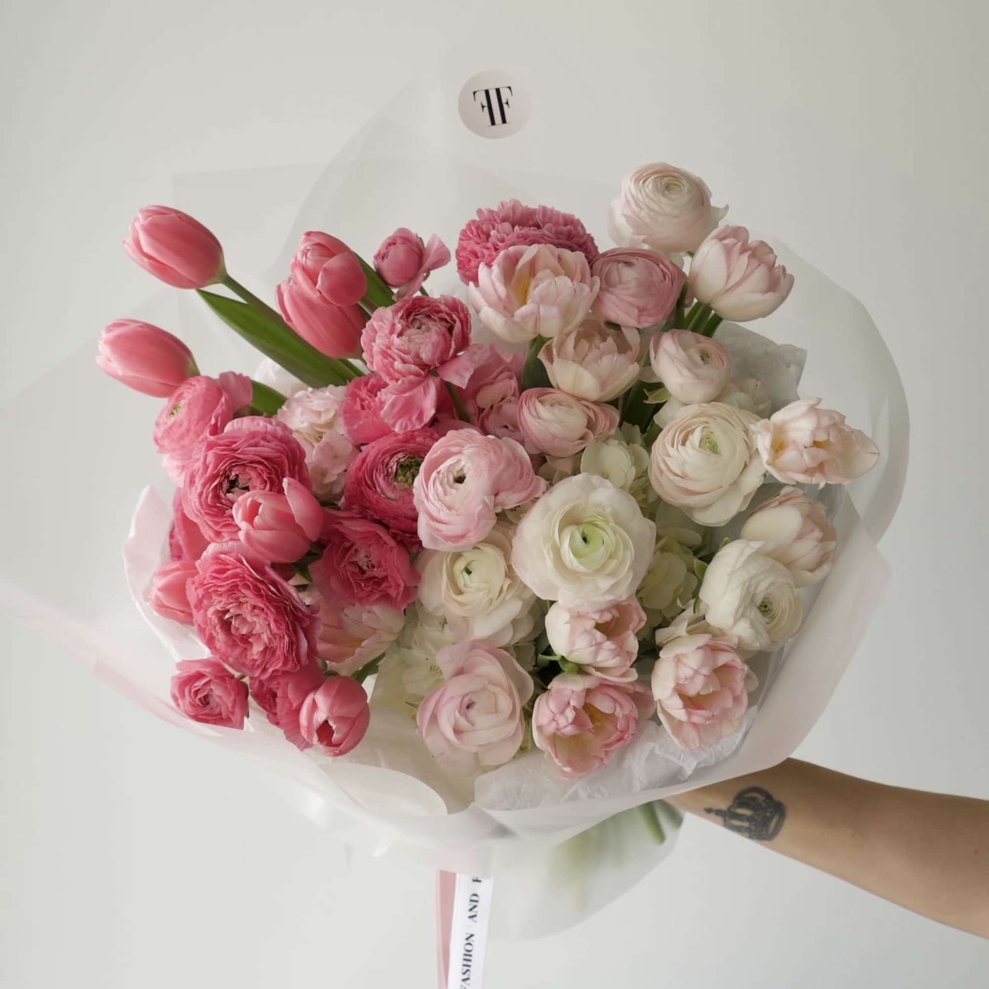 A soft, cloud-like bouquet in layered shades of pink and ivory. 
Filled