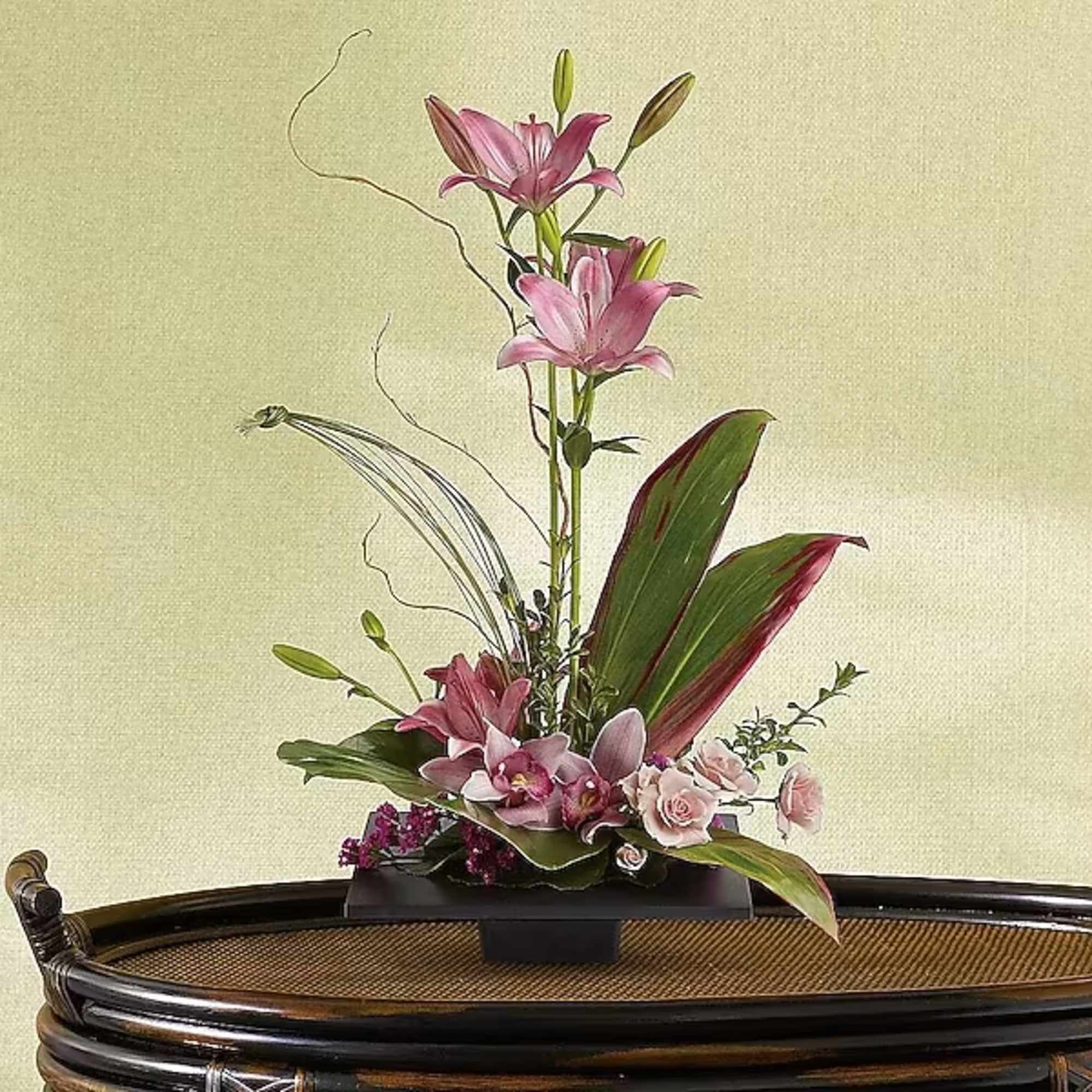 This composition of pink lilies, pink cymbidium orchids and pink roses is