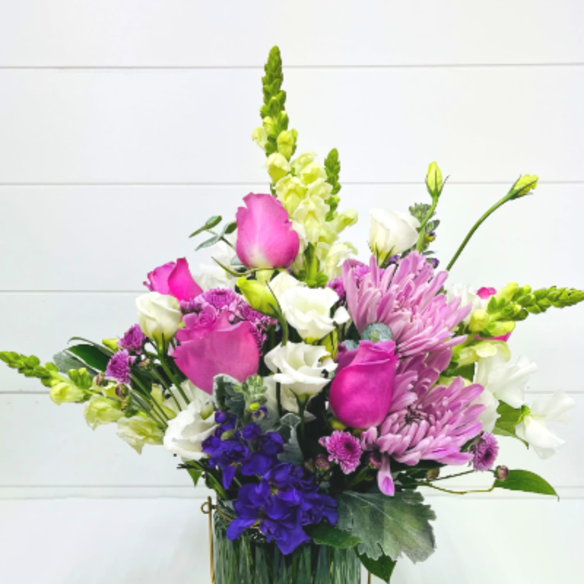 A stunning garden-style floral arrangement designed in soft shades of lavender and