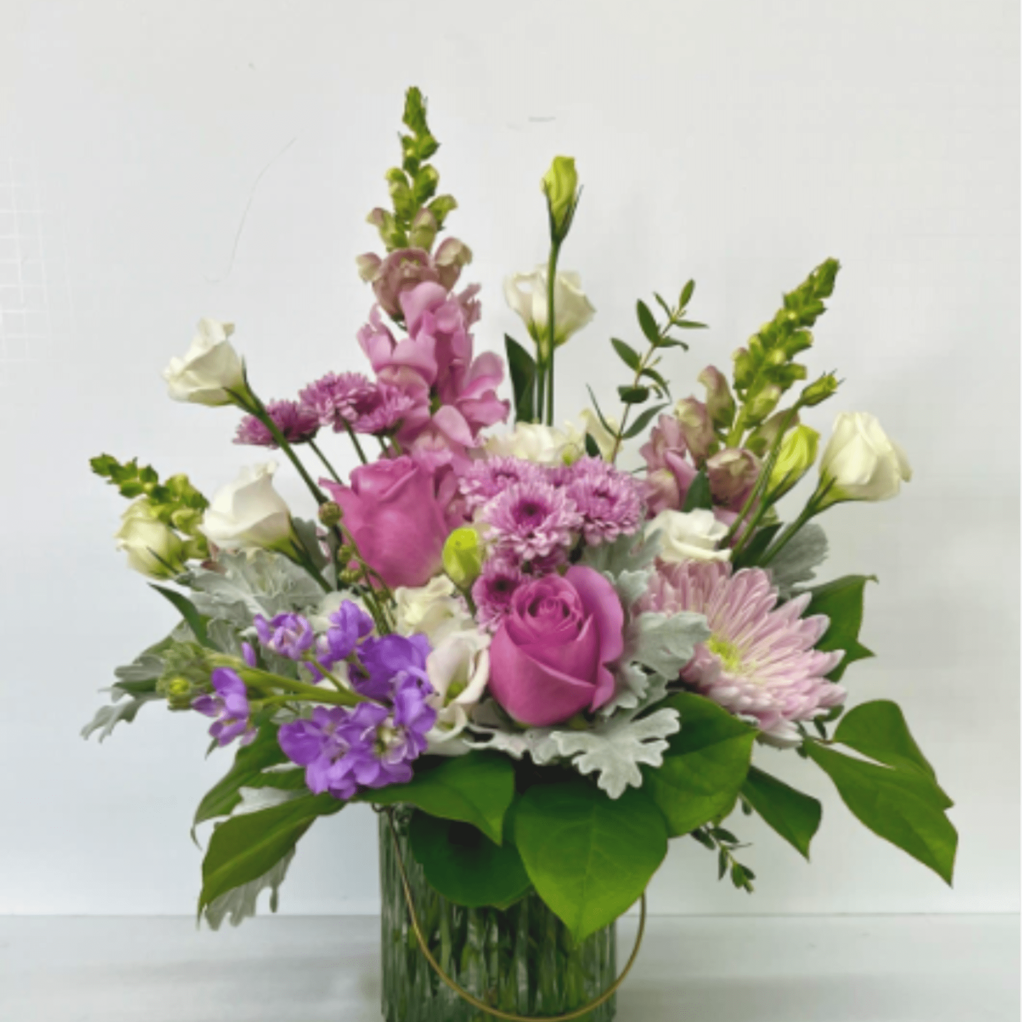 A stunning garden-style floral arrangement designed in soft shades of lavender and
