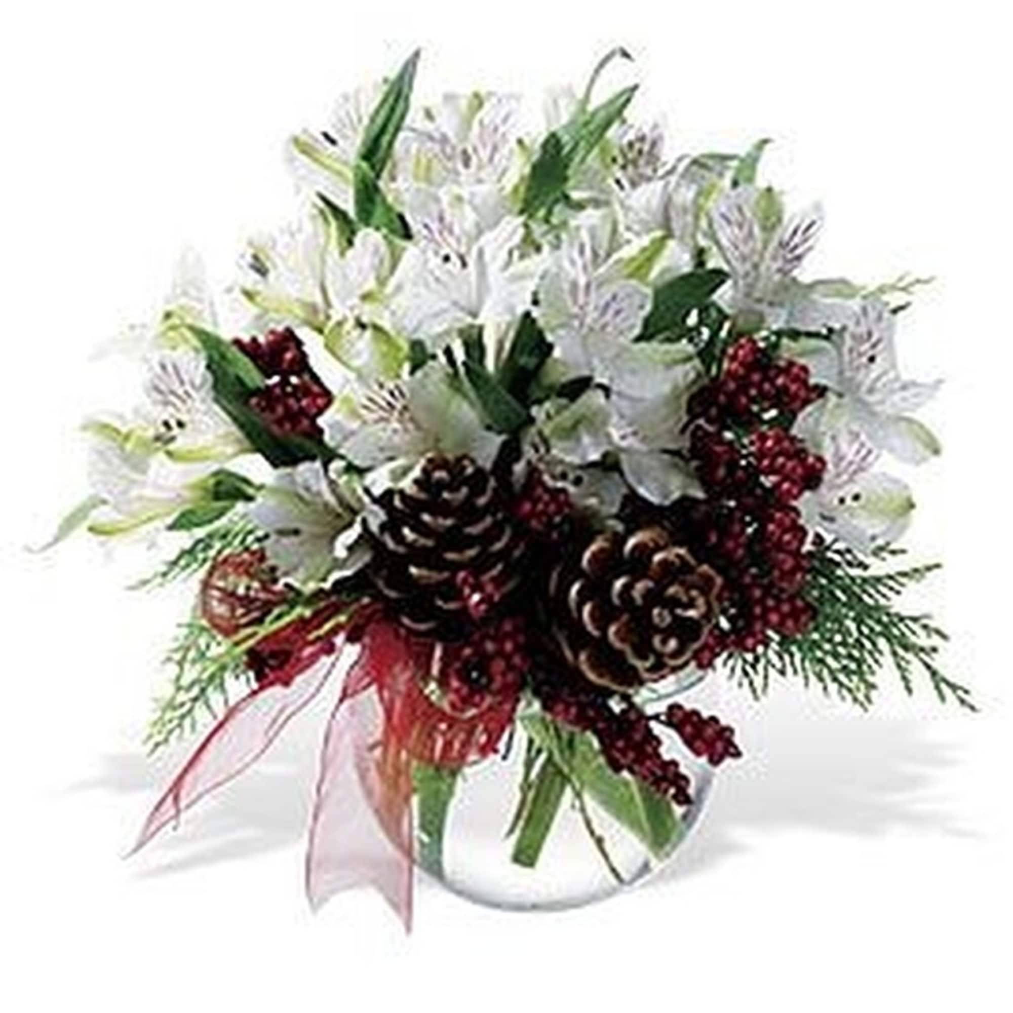 Low arrangement of white flowers with pine cones and red berries in a clear glass bowl vase.