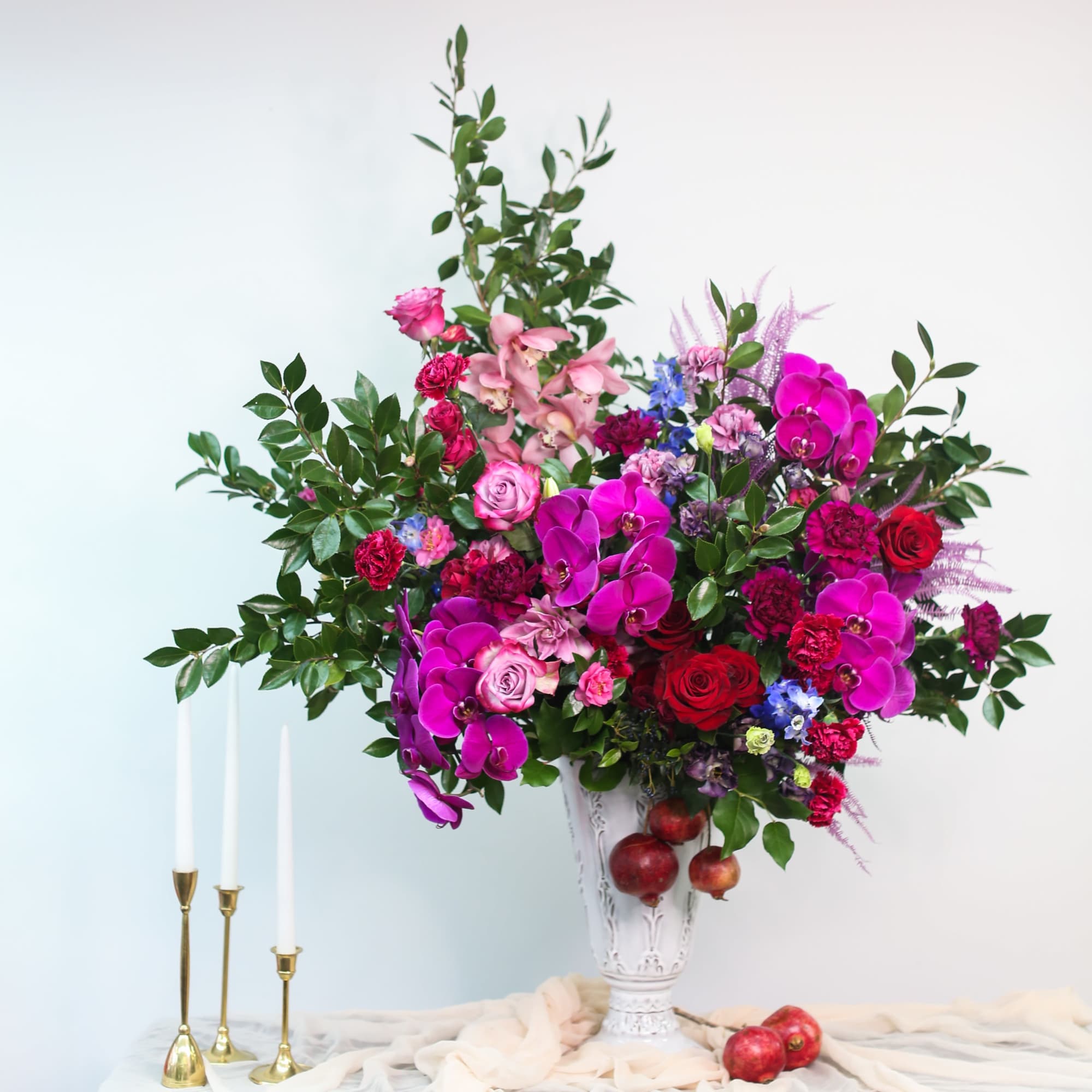 Large mixed bouquet in a white vase with pink and red flowers