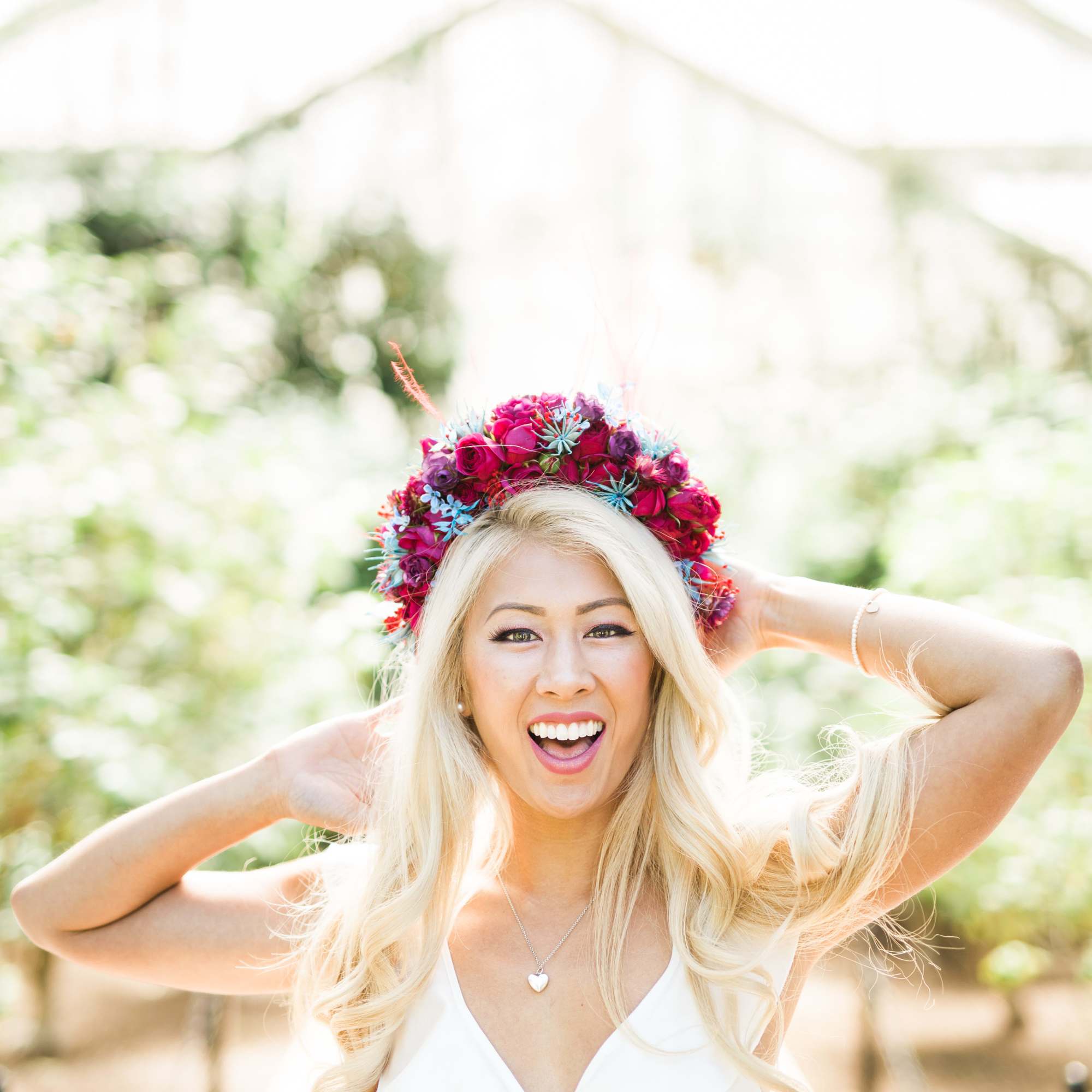 Woman wearing a colorful floral crown and white dress