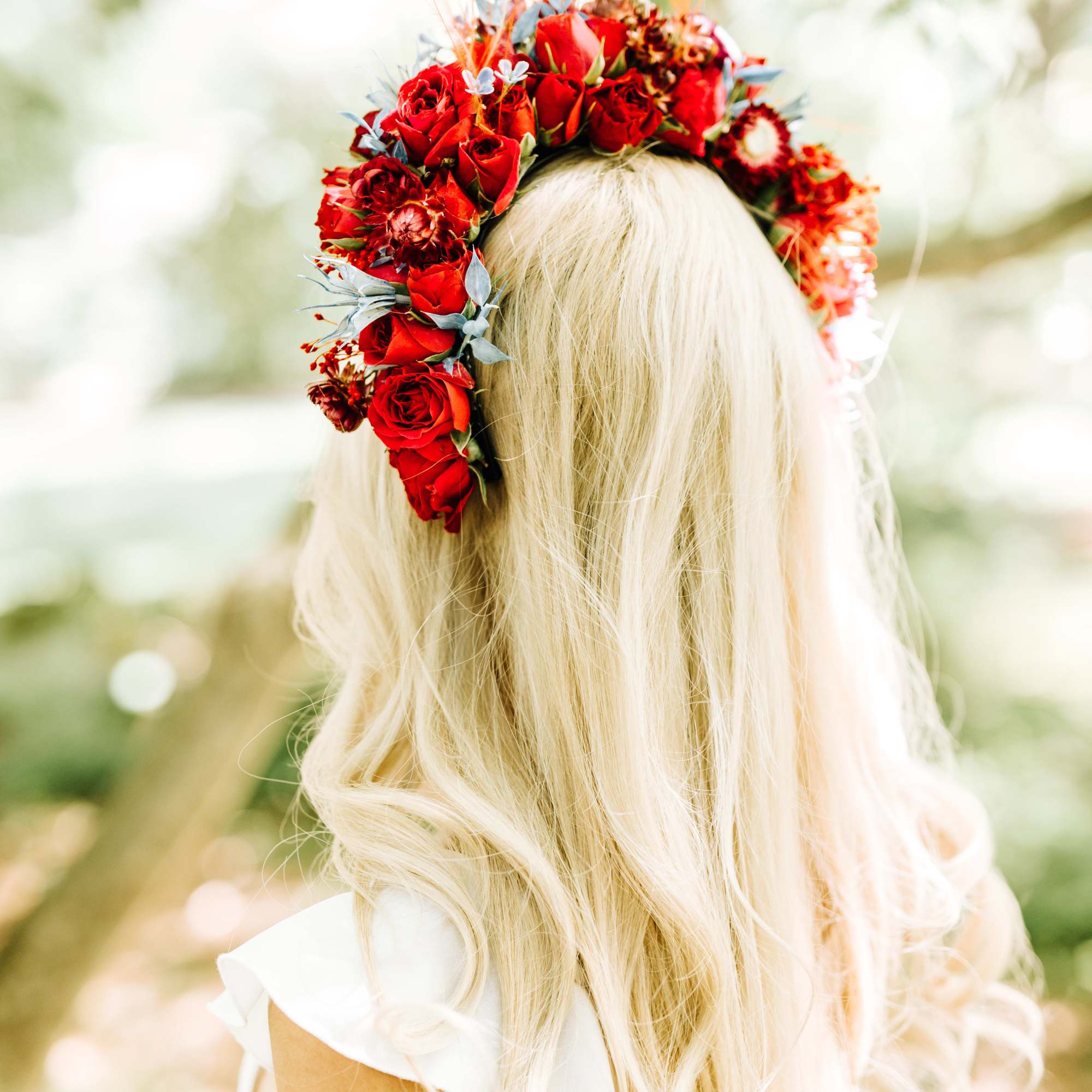Red rose flower crown on a blonde woman’s head