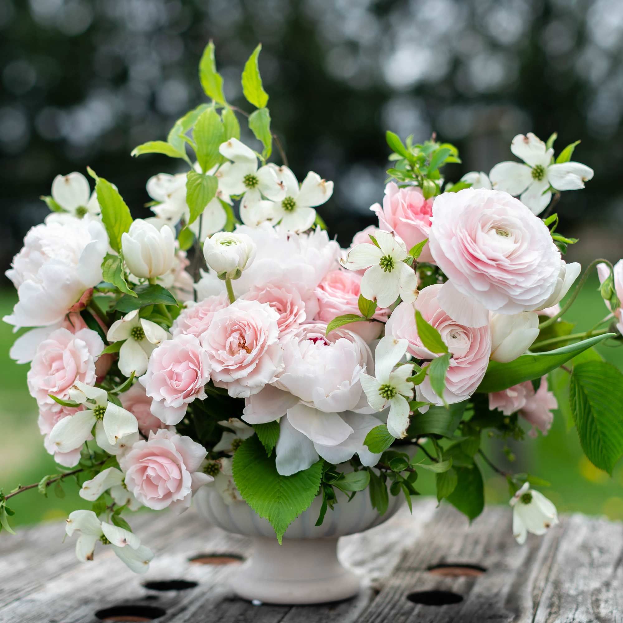 Pink and white floral arrangement in a white vase