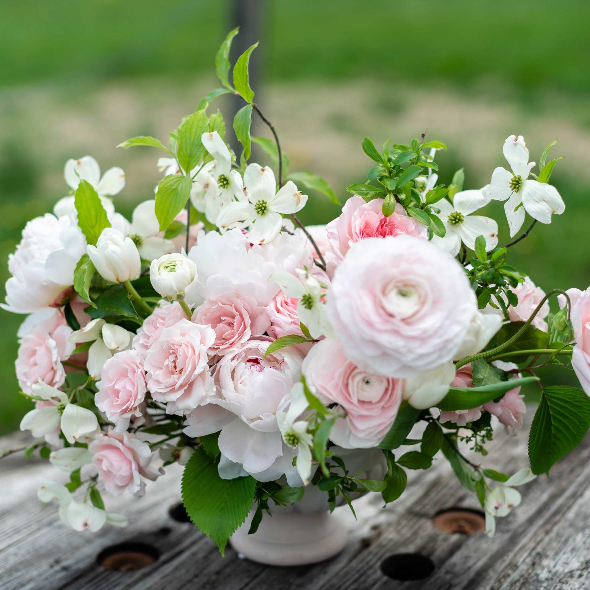 Pink and white floral arrangement in a white vase