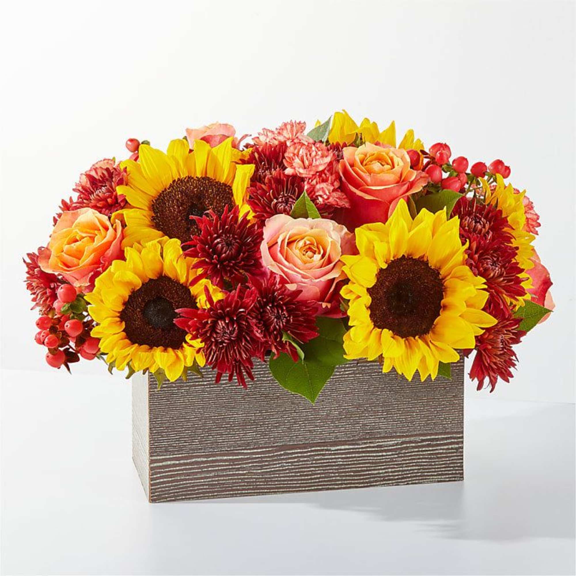 Sunflowers and roses arranged in a rectangular wooden box