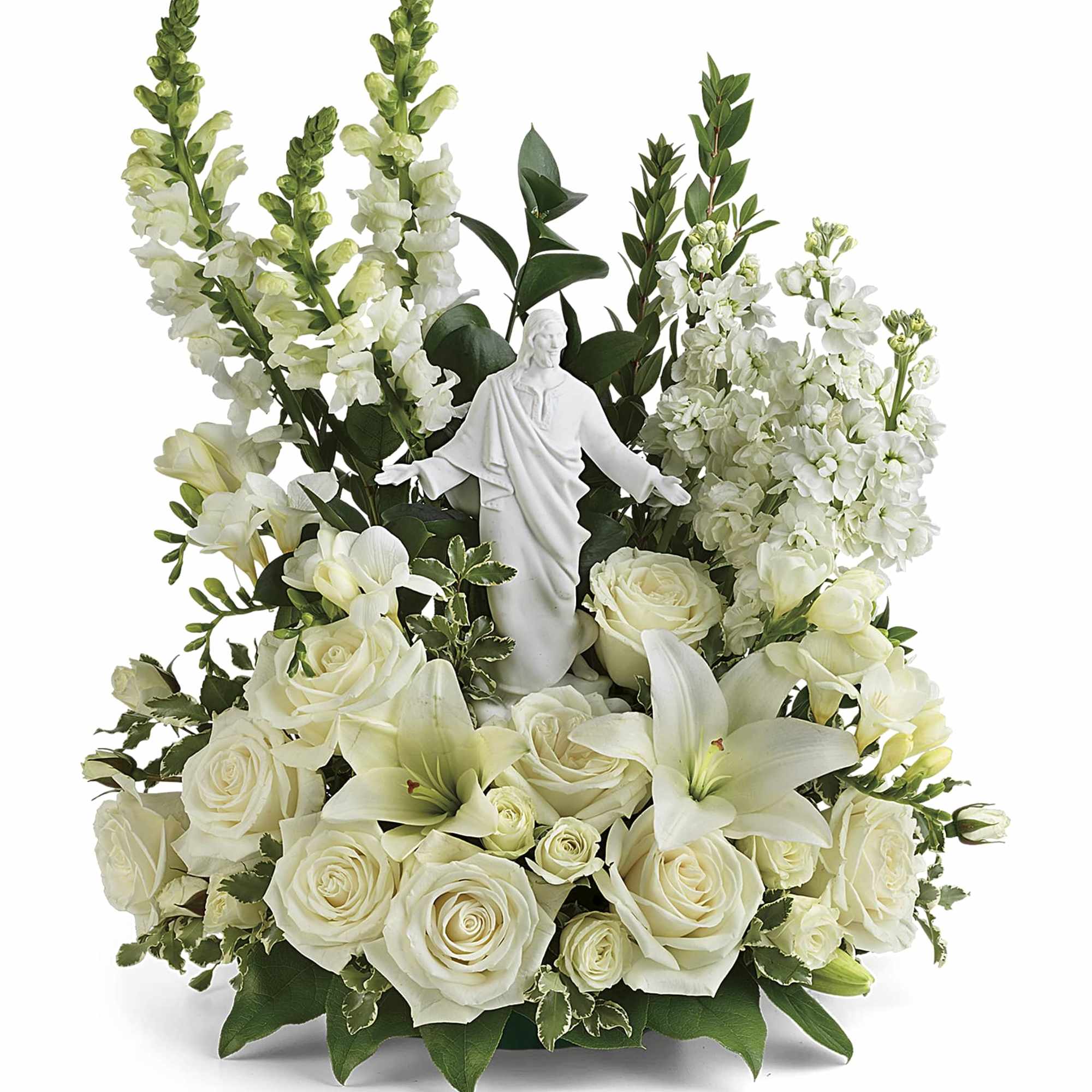 White floral arrangement with roses and lilies around a statue centerpiece