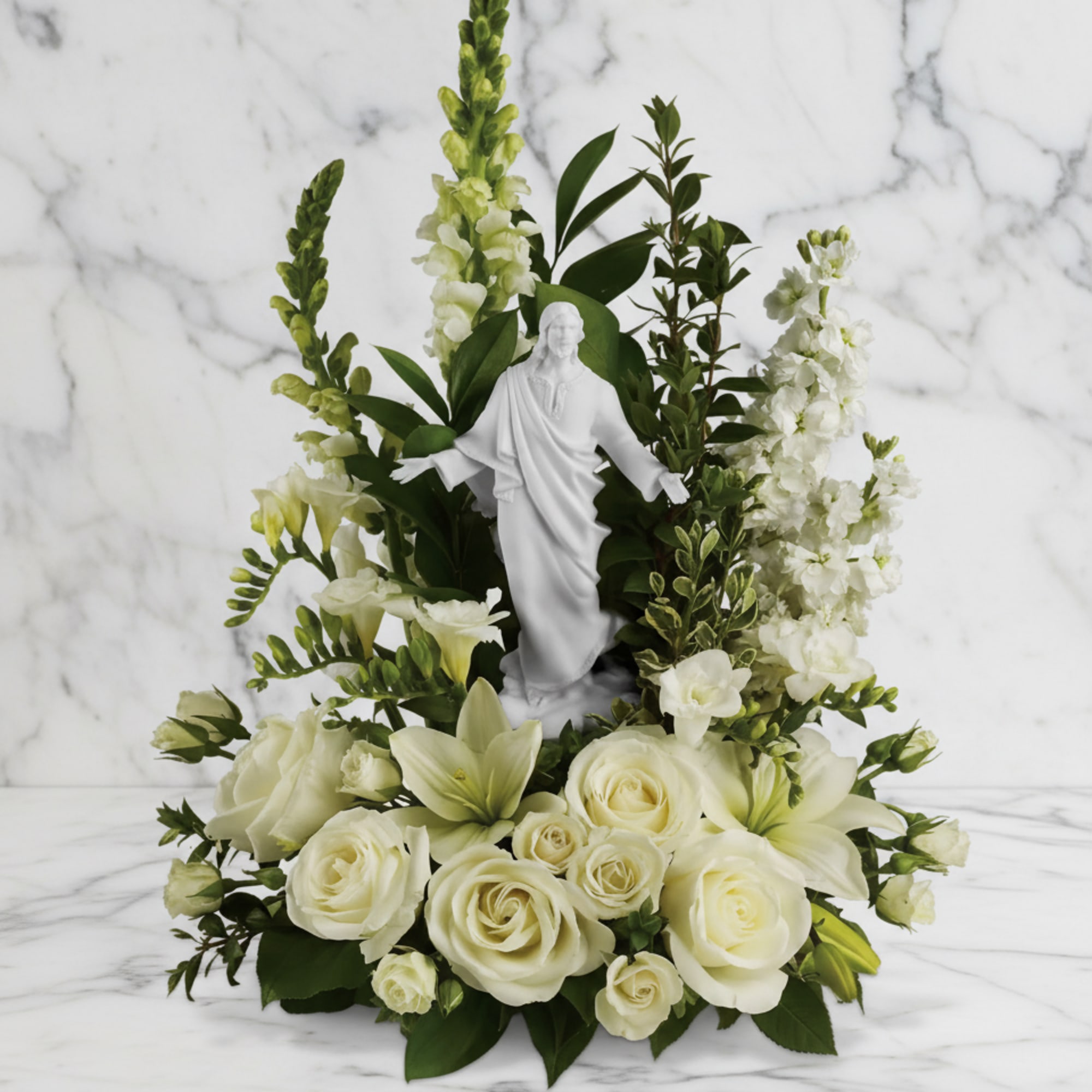 White floral arrangement with a small statue in the center