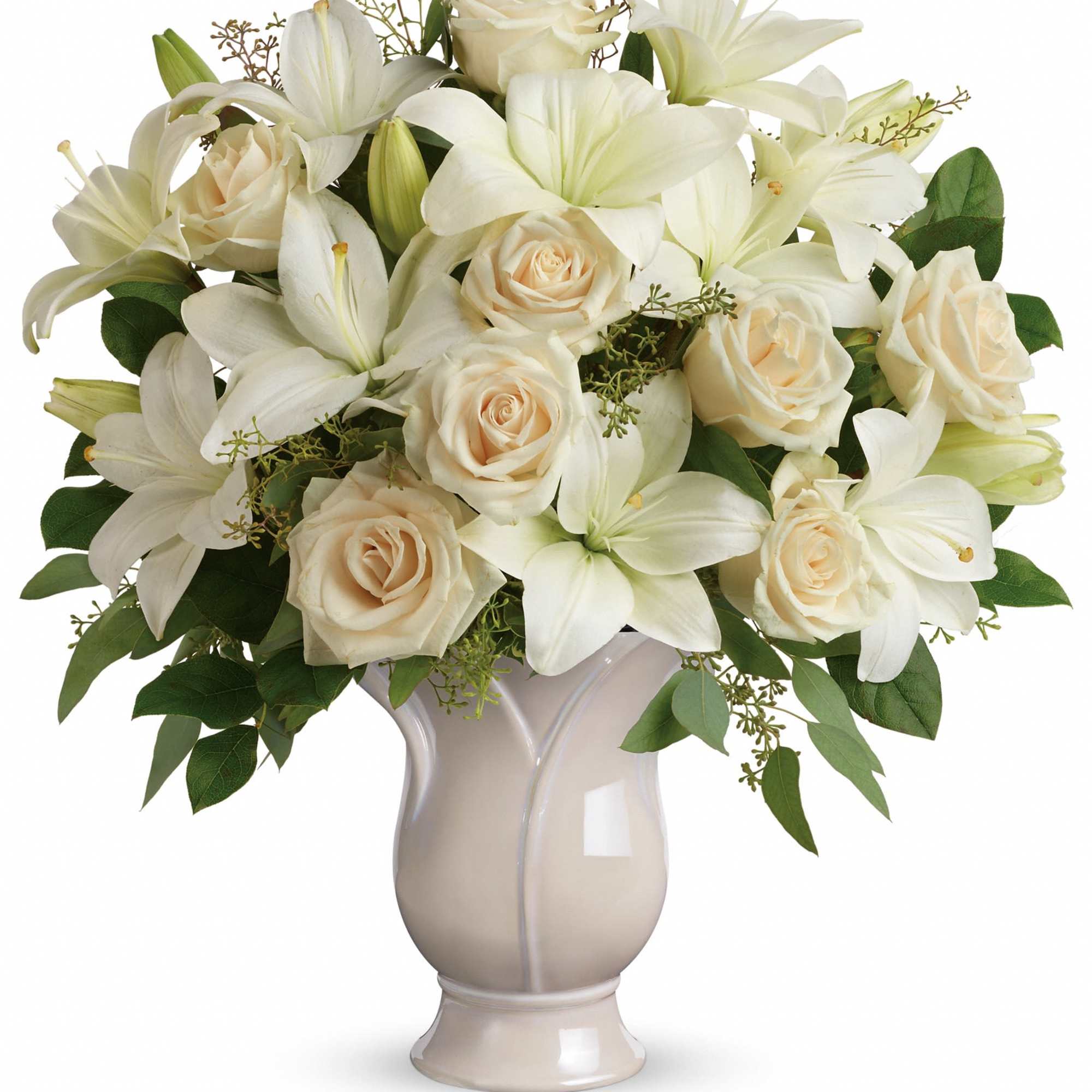 White lilies and cream roses arranged in a beige vase