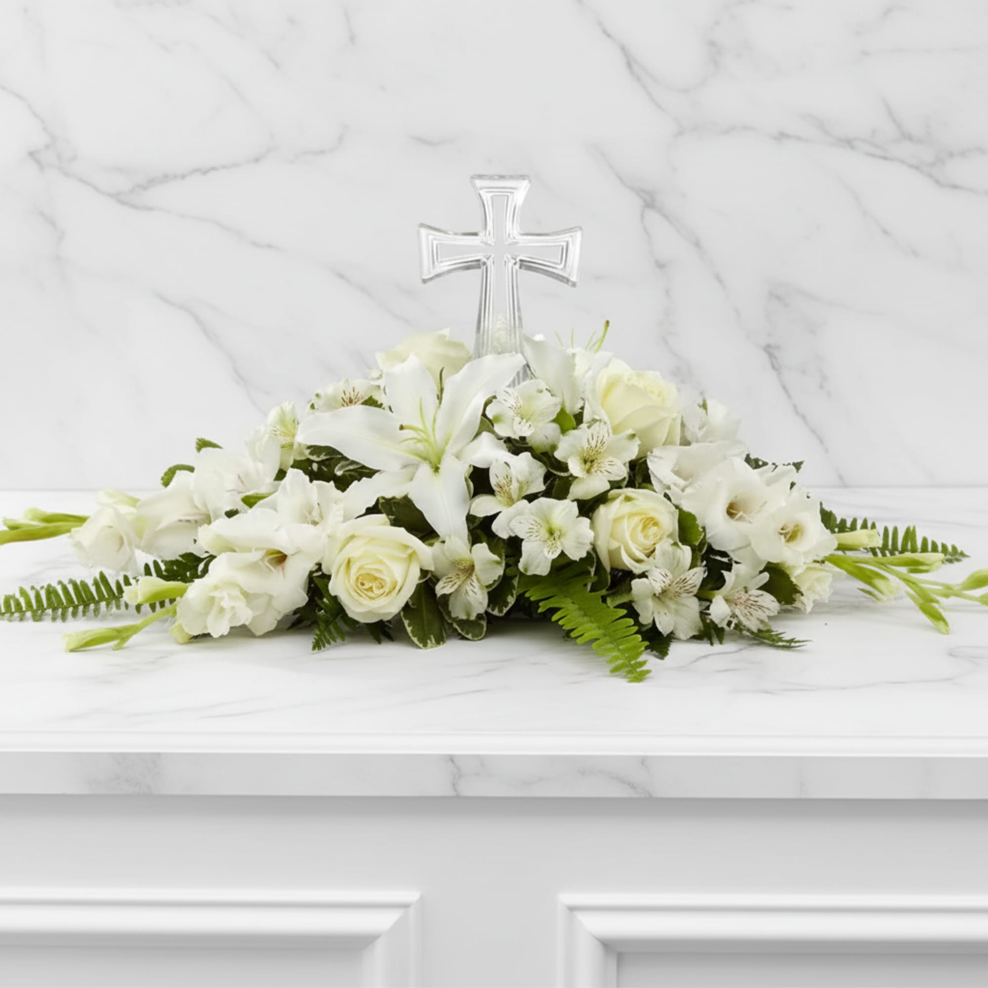 White floral arrangement with a clear cross centerpiece