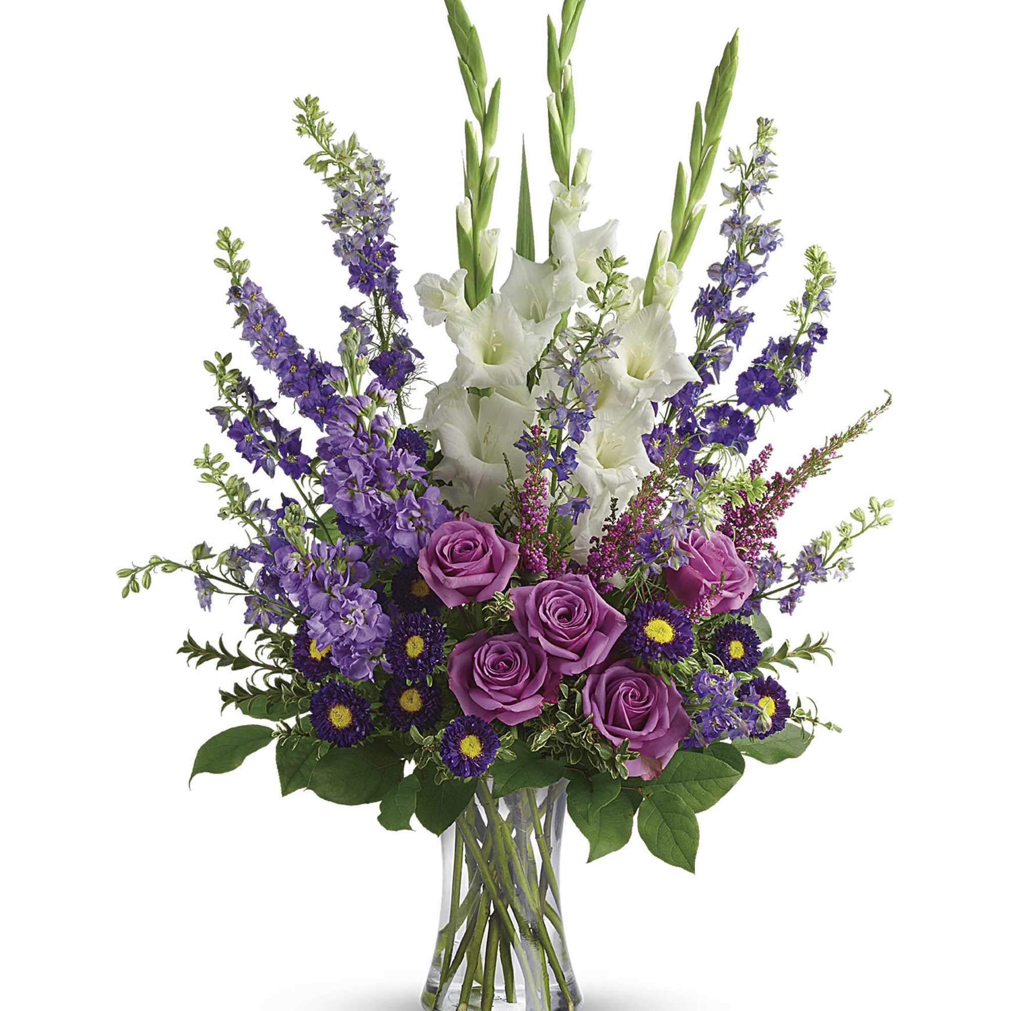 Purple roses and white gladiolus in a clear glass vase
