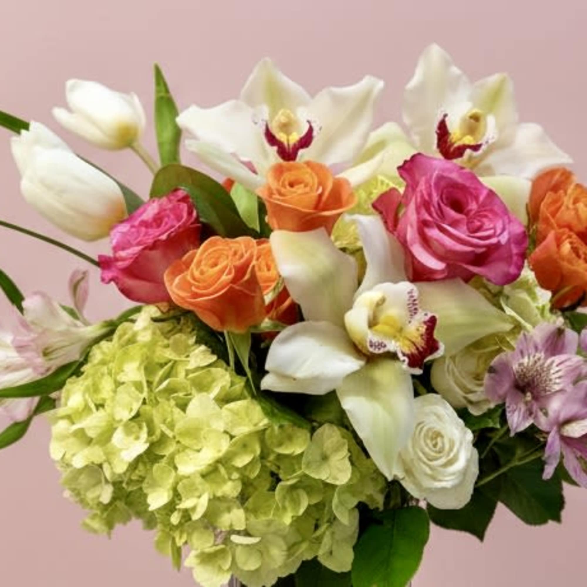 A luxurious blend of orchids, roses, hydrangeas, and seasonal blooms, thoughtfully designed