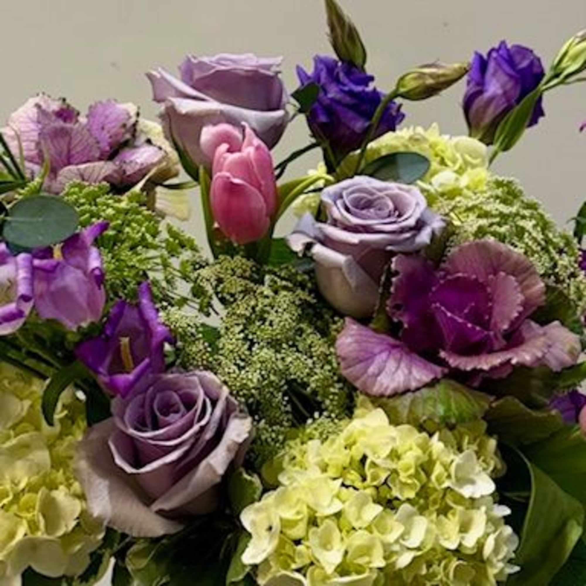 A lush blend of hydrangeas, lisianthus, roses, and seasonal blooms, thoughtfully arranged