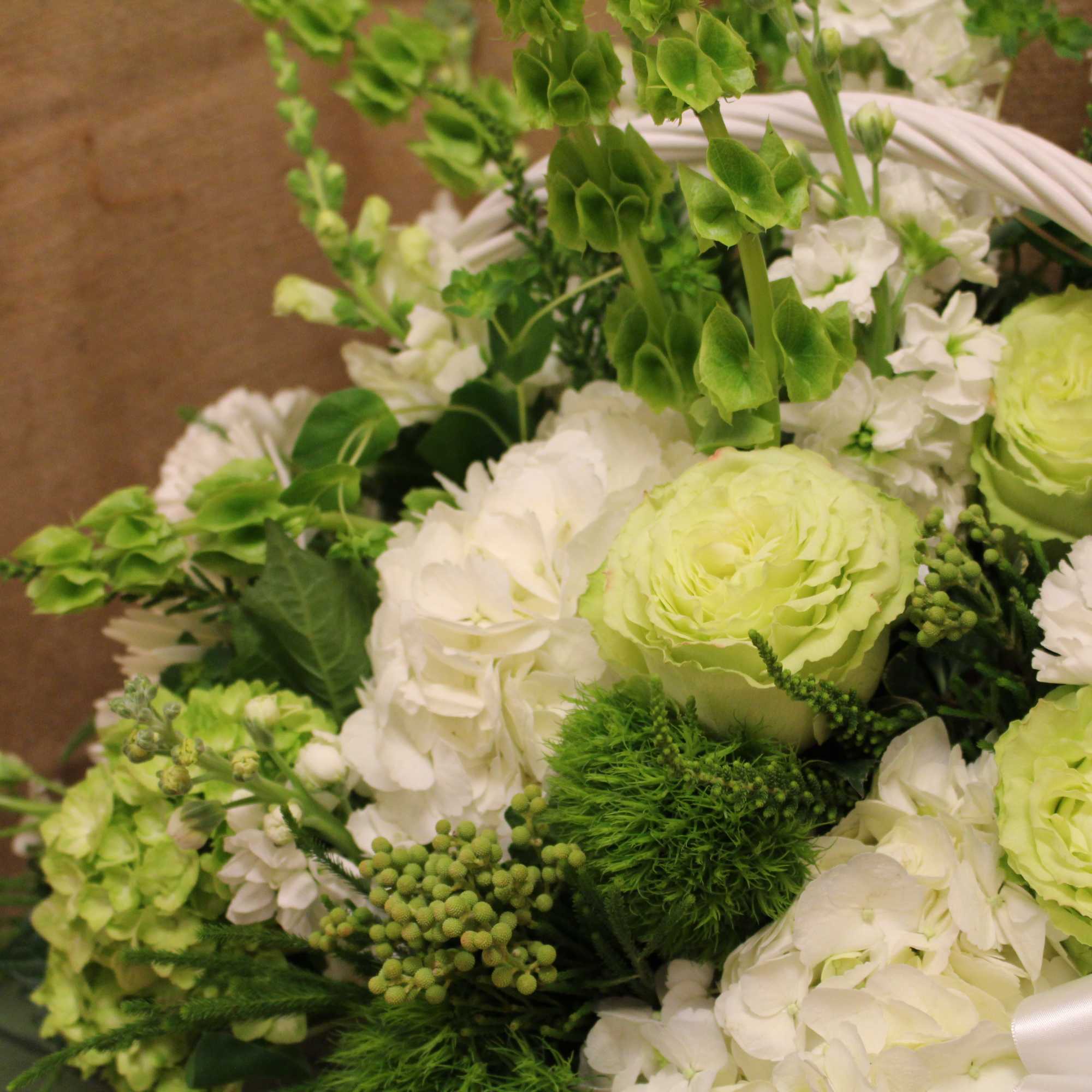 Green and white bouquet with round blooms and white ribbon