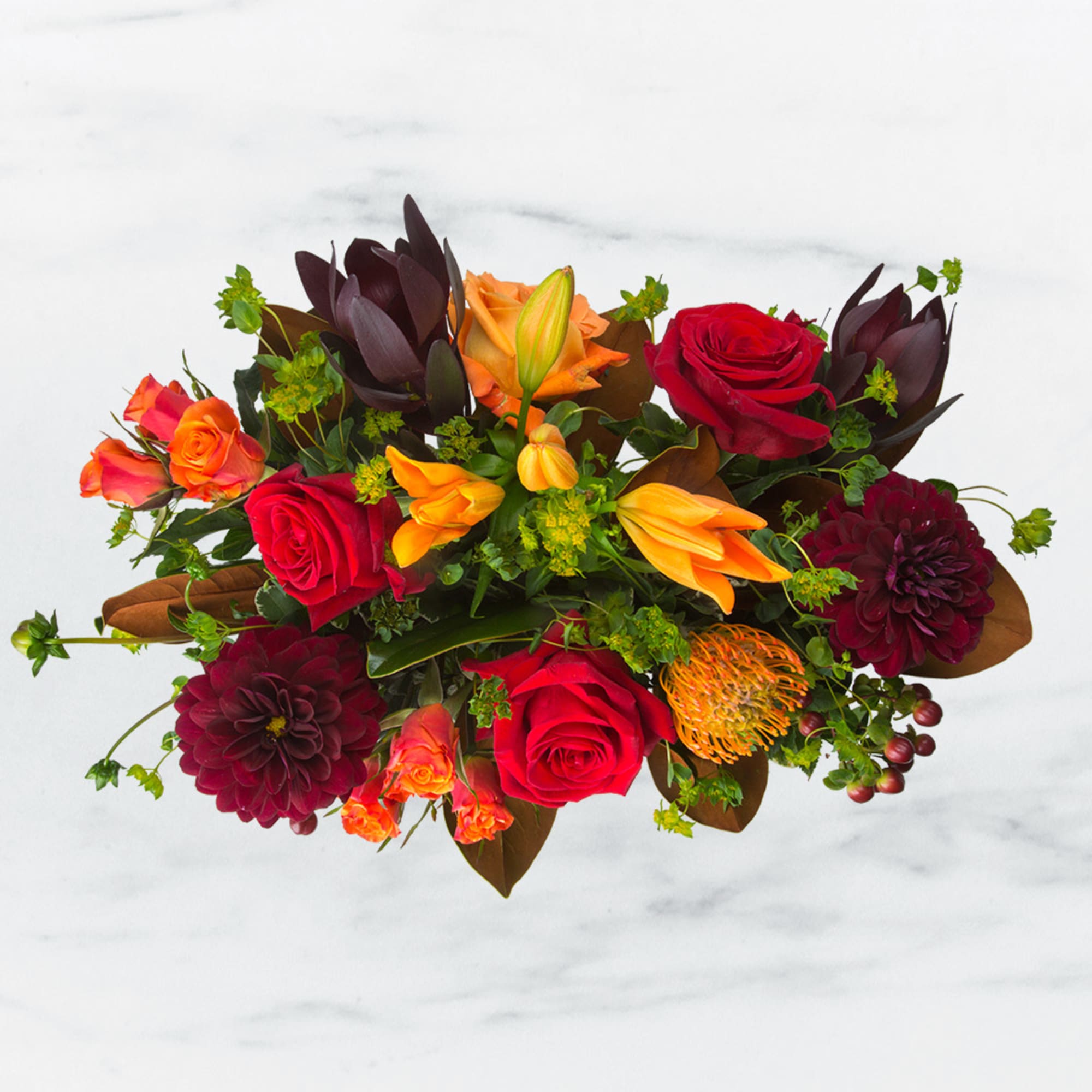 Mixed bouquet with red and orange roses, dark dahlias, and orange lilies