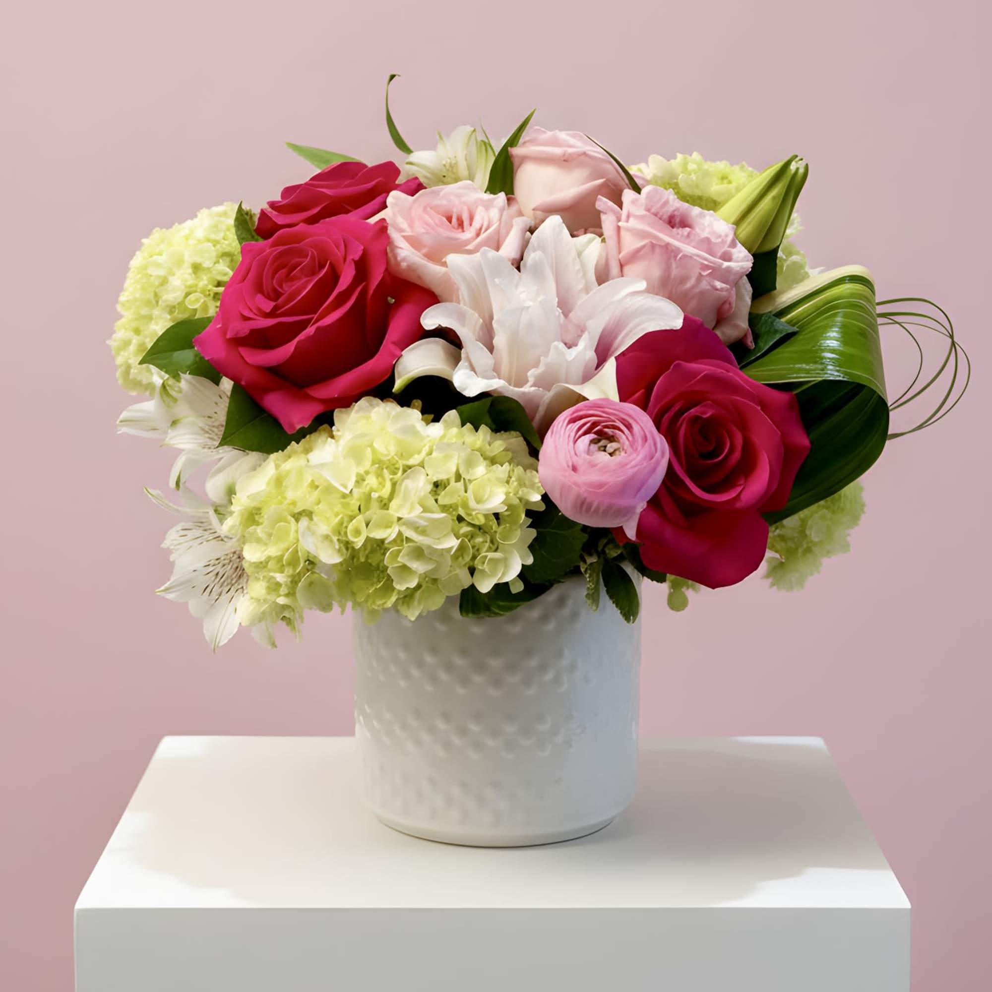 A curated mix of soft and bold pink blooms, artfully arranged to