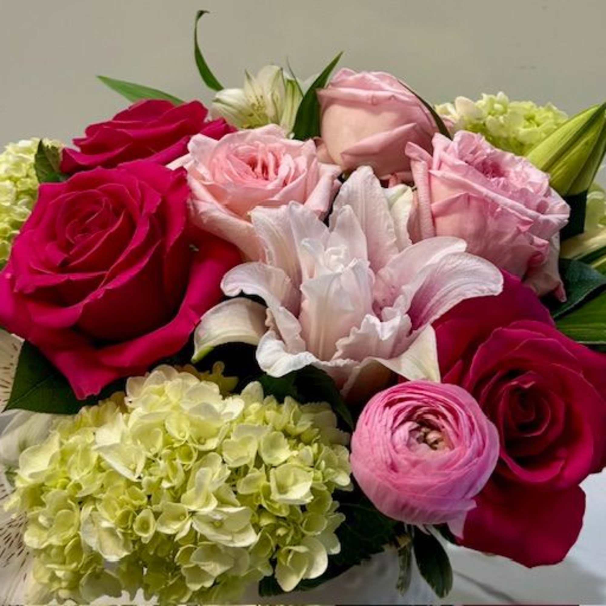 A curated mix of soft and bold pink blooms, artfully arranged to