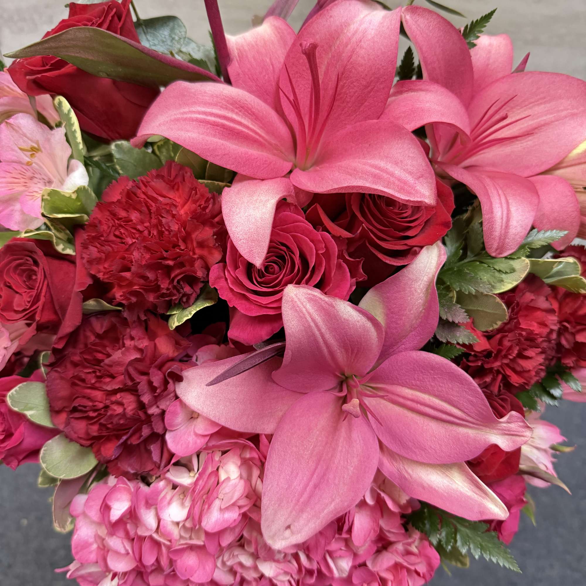 Pink lily and rose bouquet with hydrangea and carnations