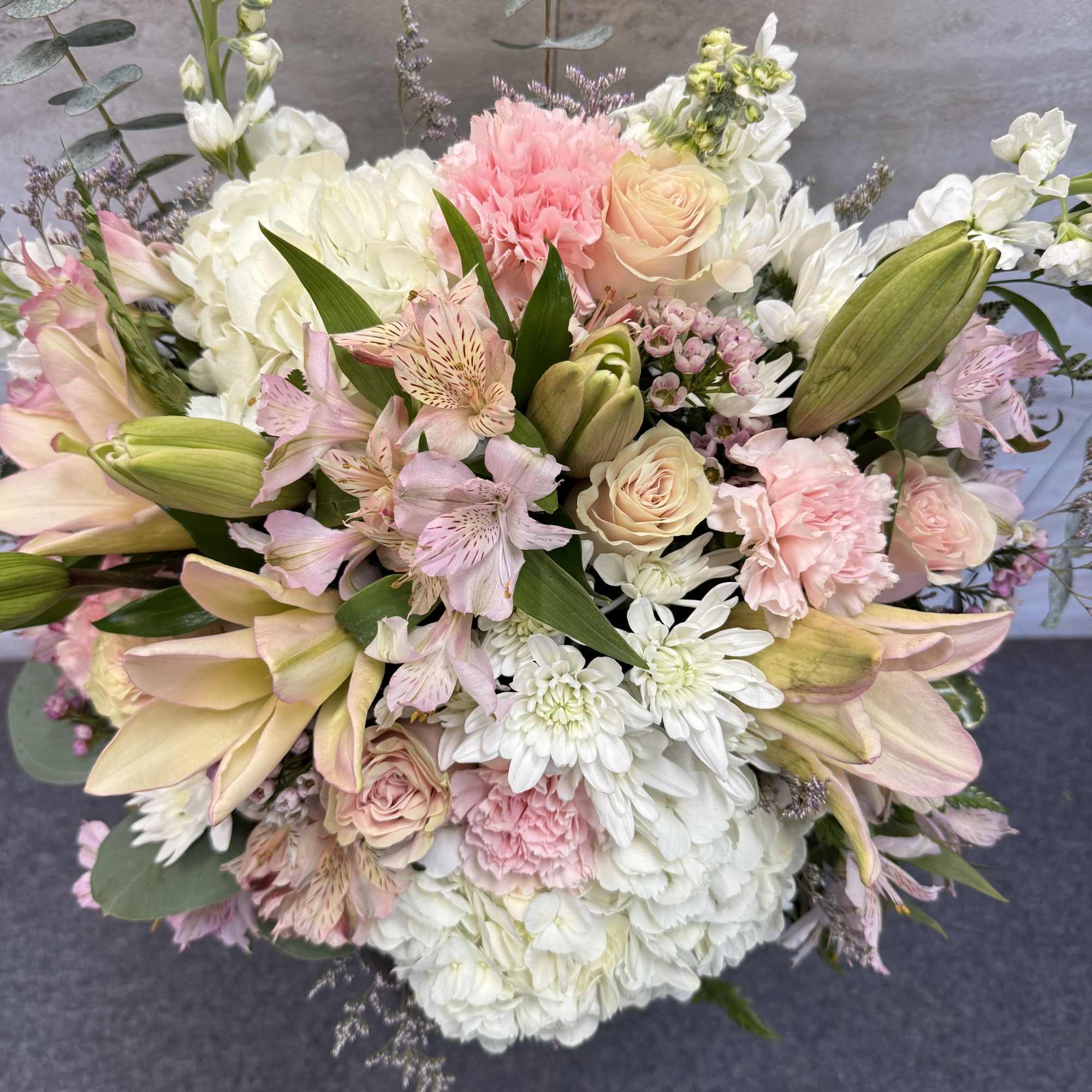 Pastel bouquet with lilies, roses, carnations, and white chrysanthemums