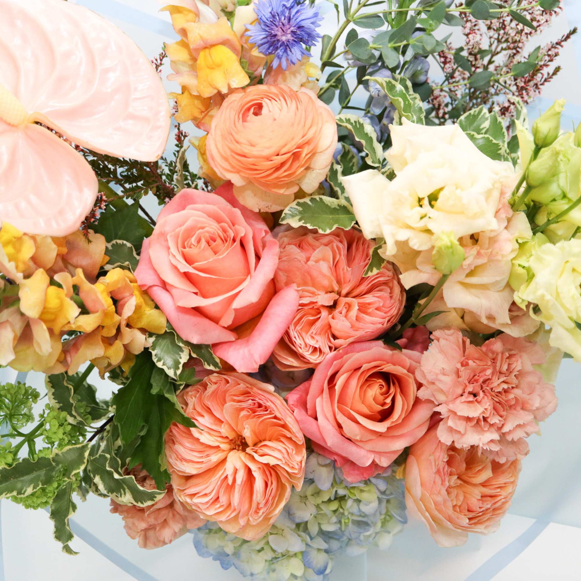 Pastel bouquet with roses, anthurium, and mixed blooms
