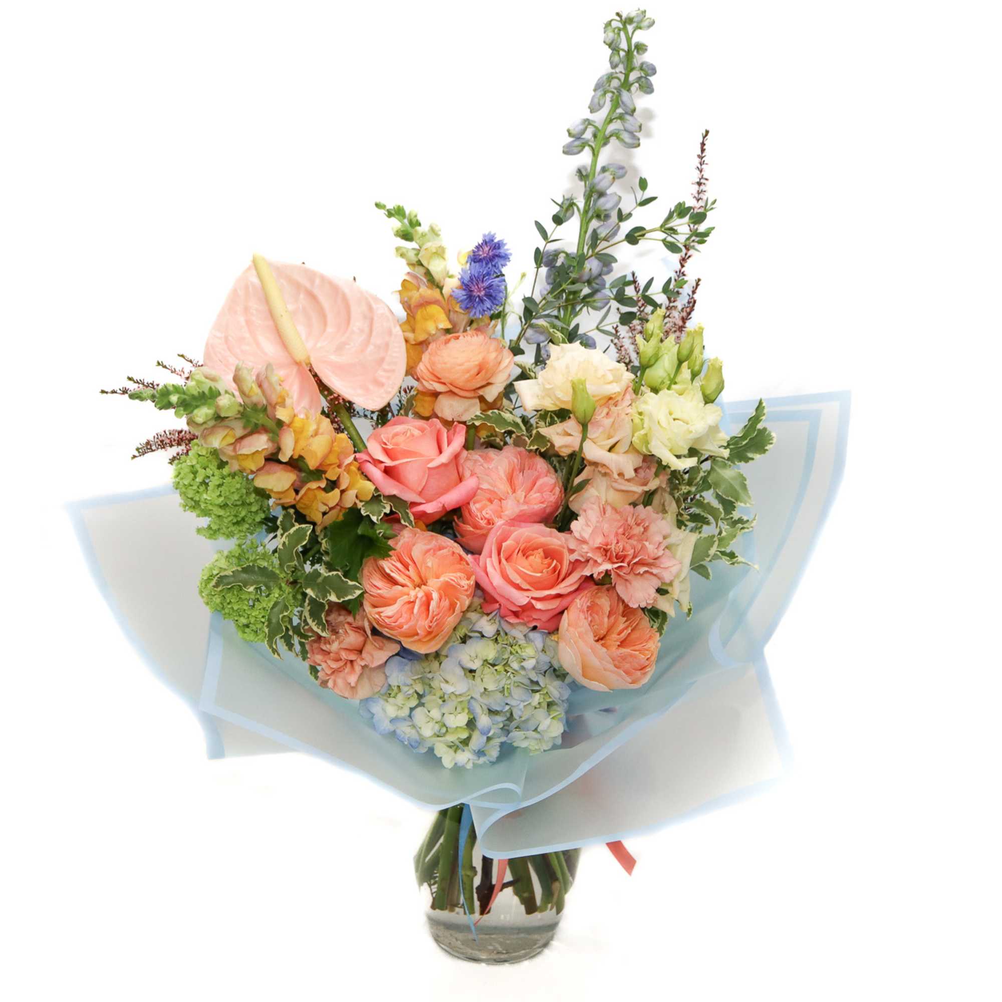 Pastel bouquet with roses, hydrangea, and anthurium in a glass vase
