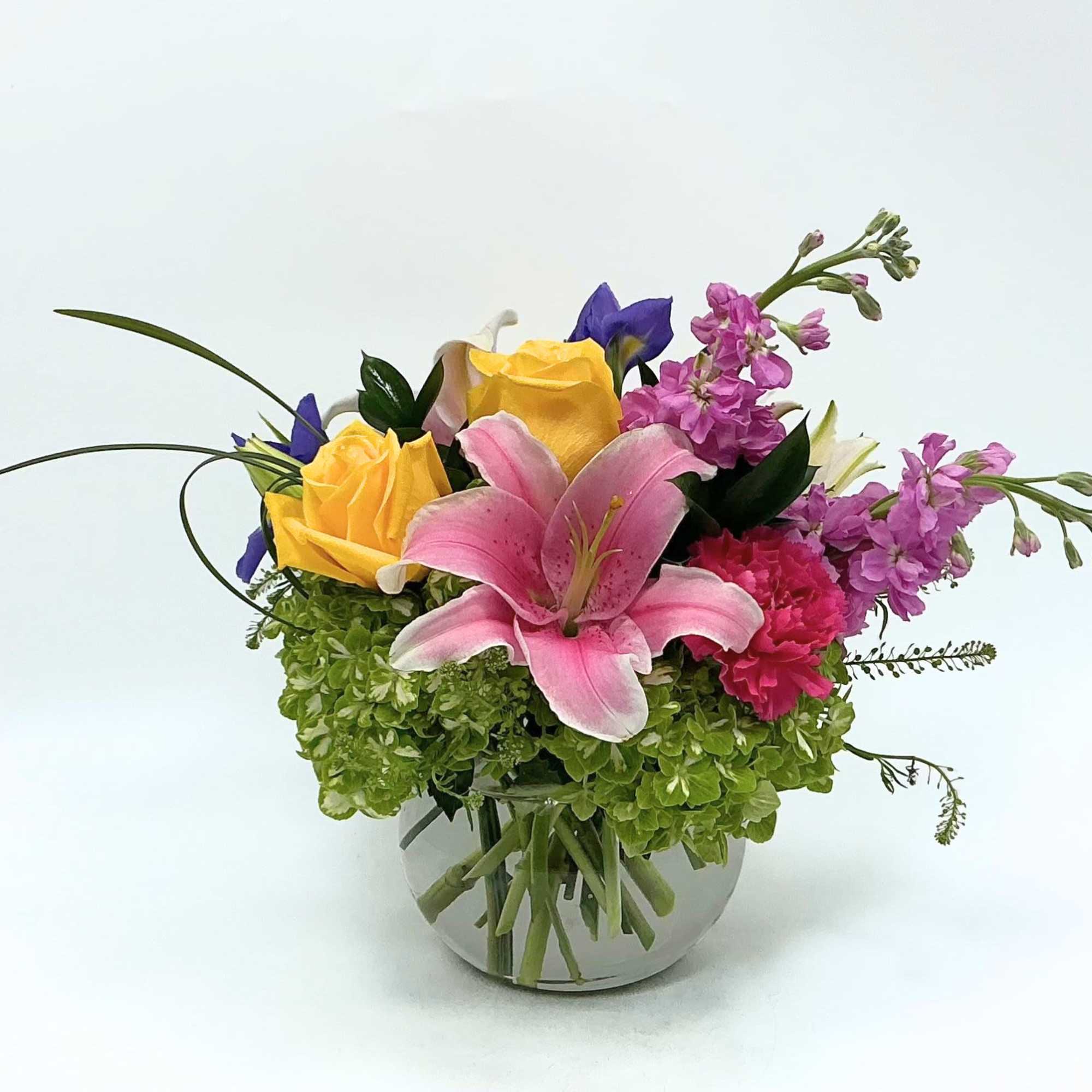 Springtime Oasis features a curated collection of premium seasonal blooms, including pink