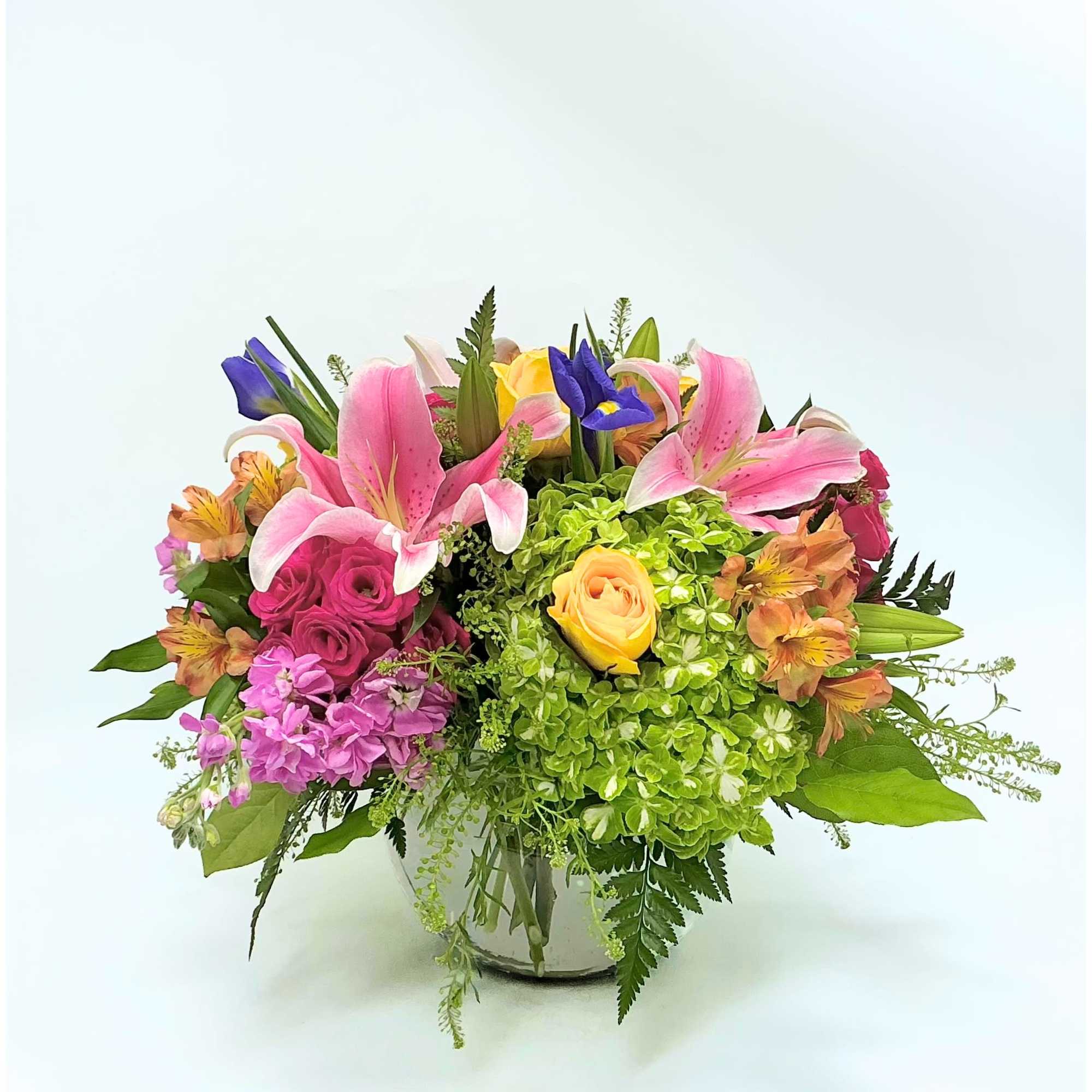 Springtime Oasis features a curated collection of premium seasonal blooms, including pink