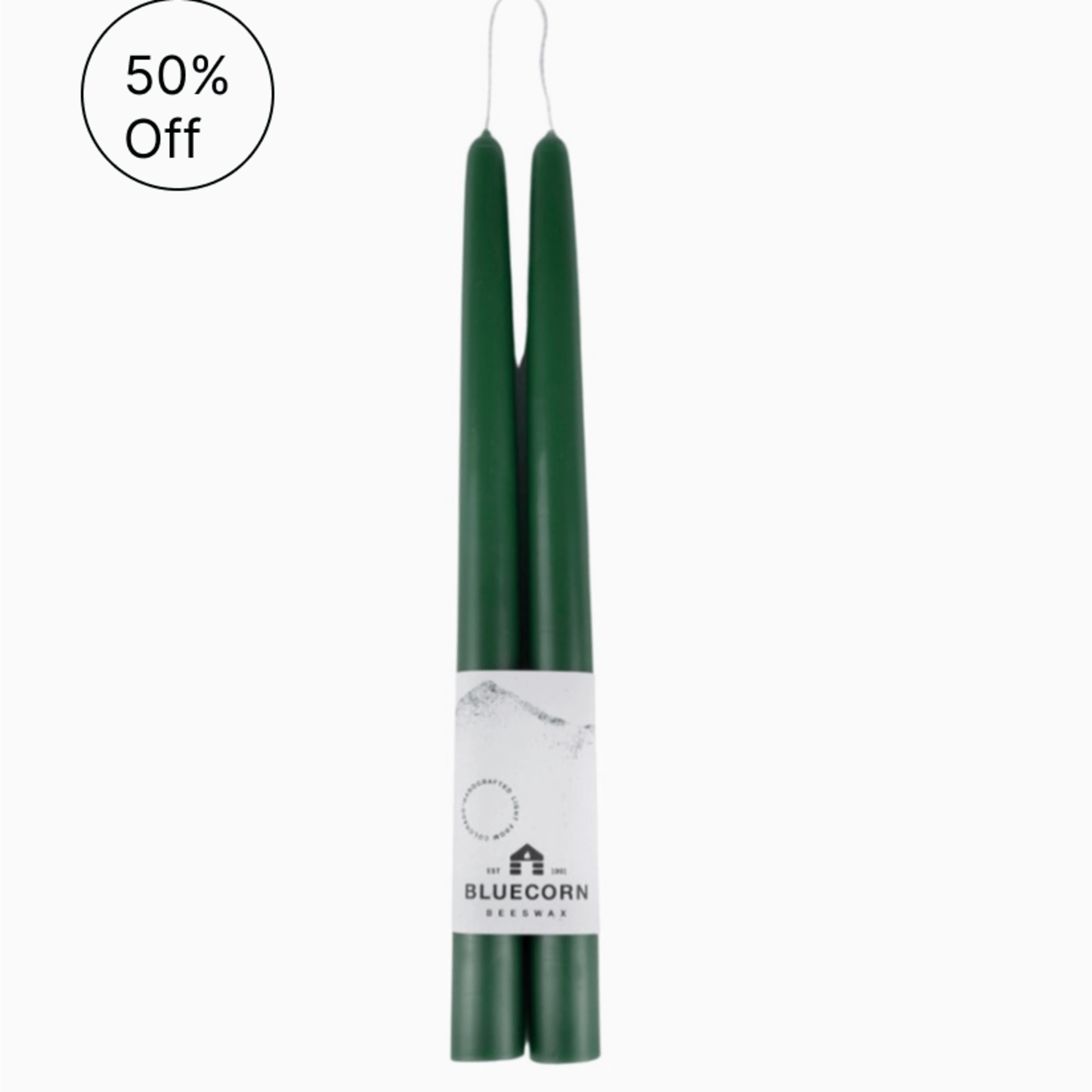 Pair of dark green taper candles bound together with a white Bluecorn Beeswax label