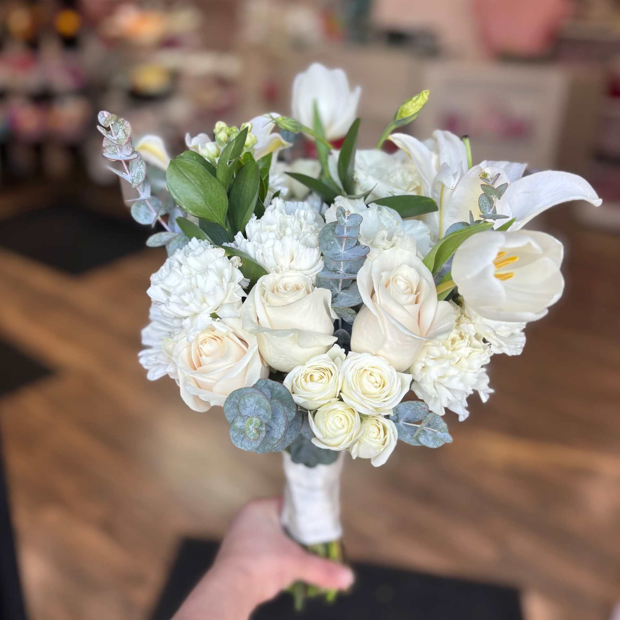 White rose and tulip bouquet with eucalyptus accents