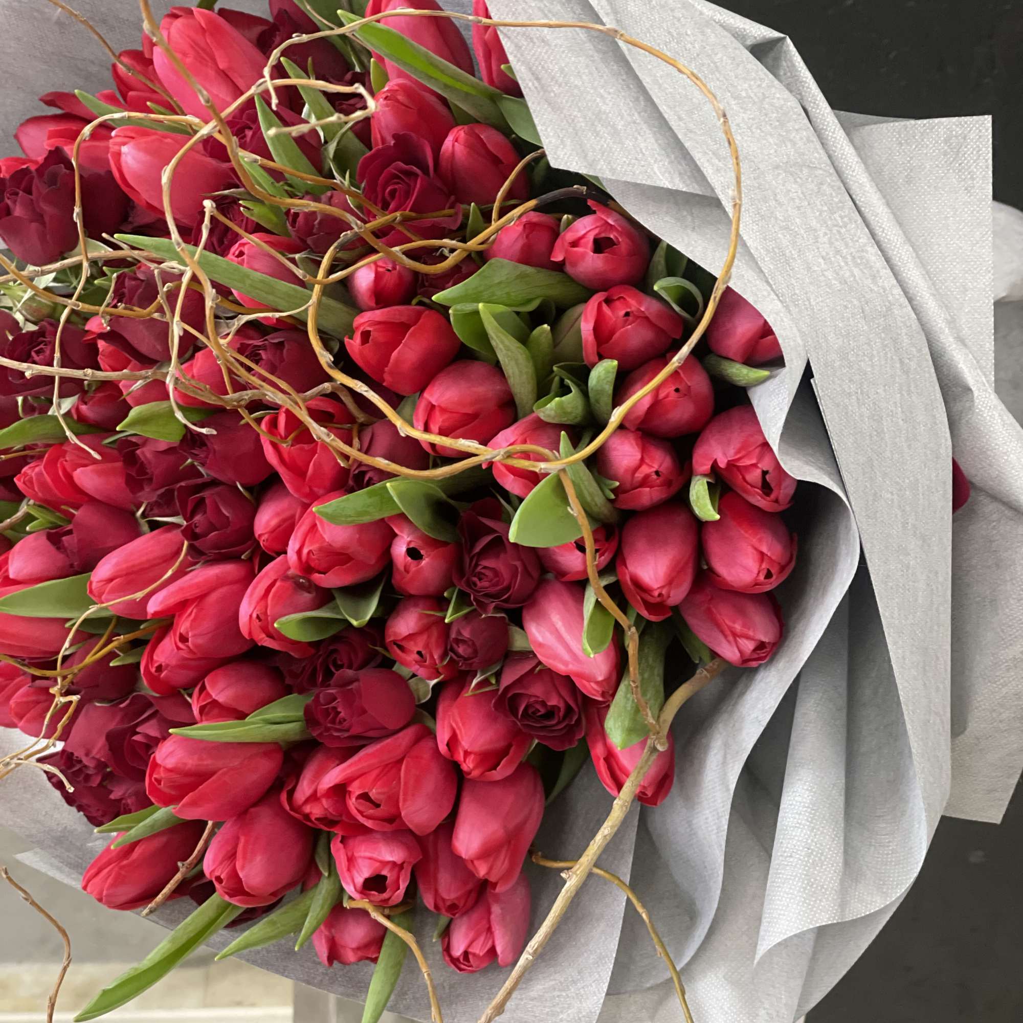 Bouquet of pink tulips wrapped in silver paper