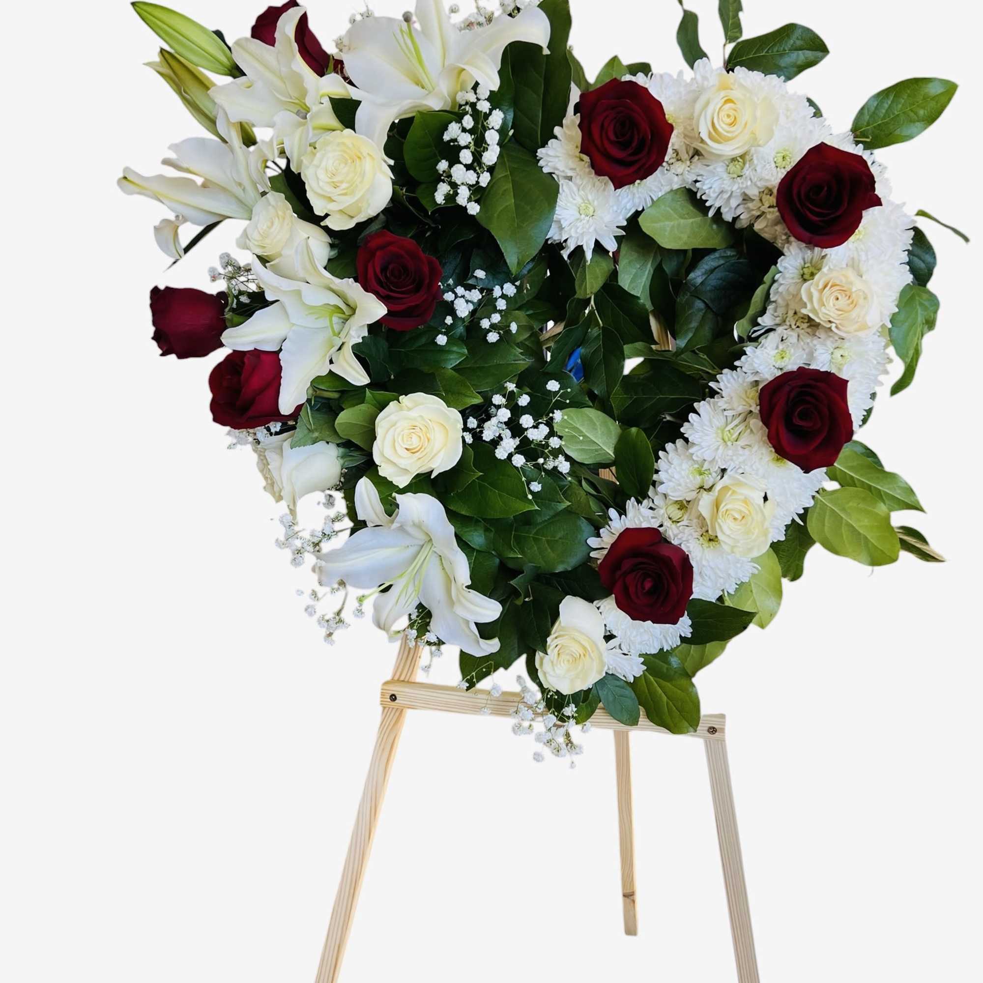A beautiful heart-shaped arrangement of red and white roses, symbolizing love, respect