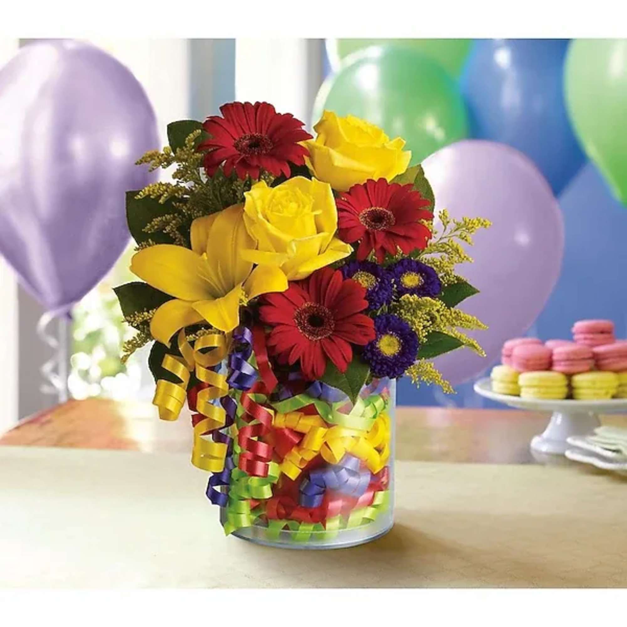 Say "Happy Birthday" with flowers! Festive ribbons decorate the refillable vase of