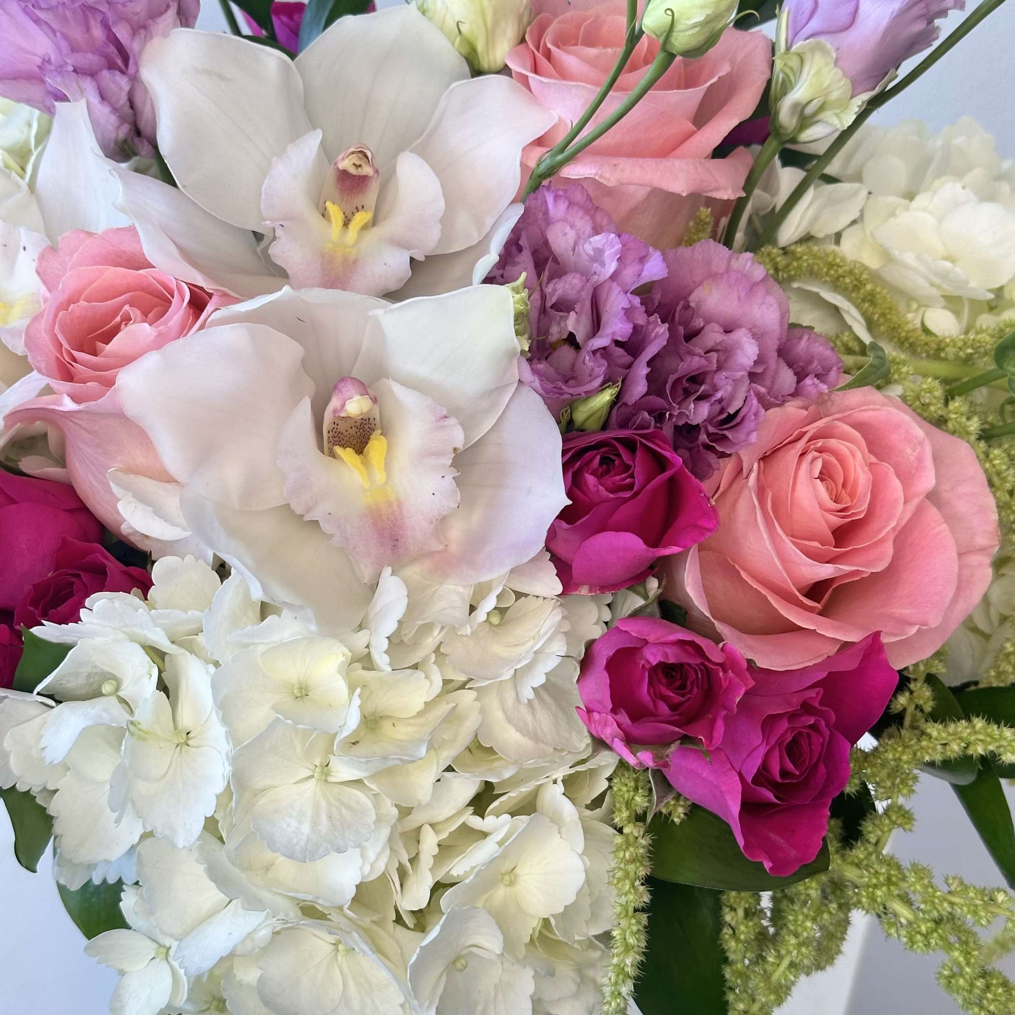 Bouquet of pink roses, white orchids, and white hydrangea
