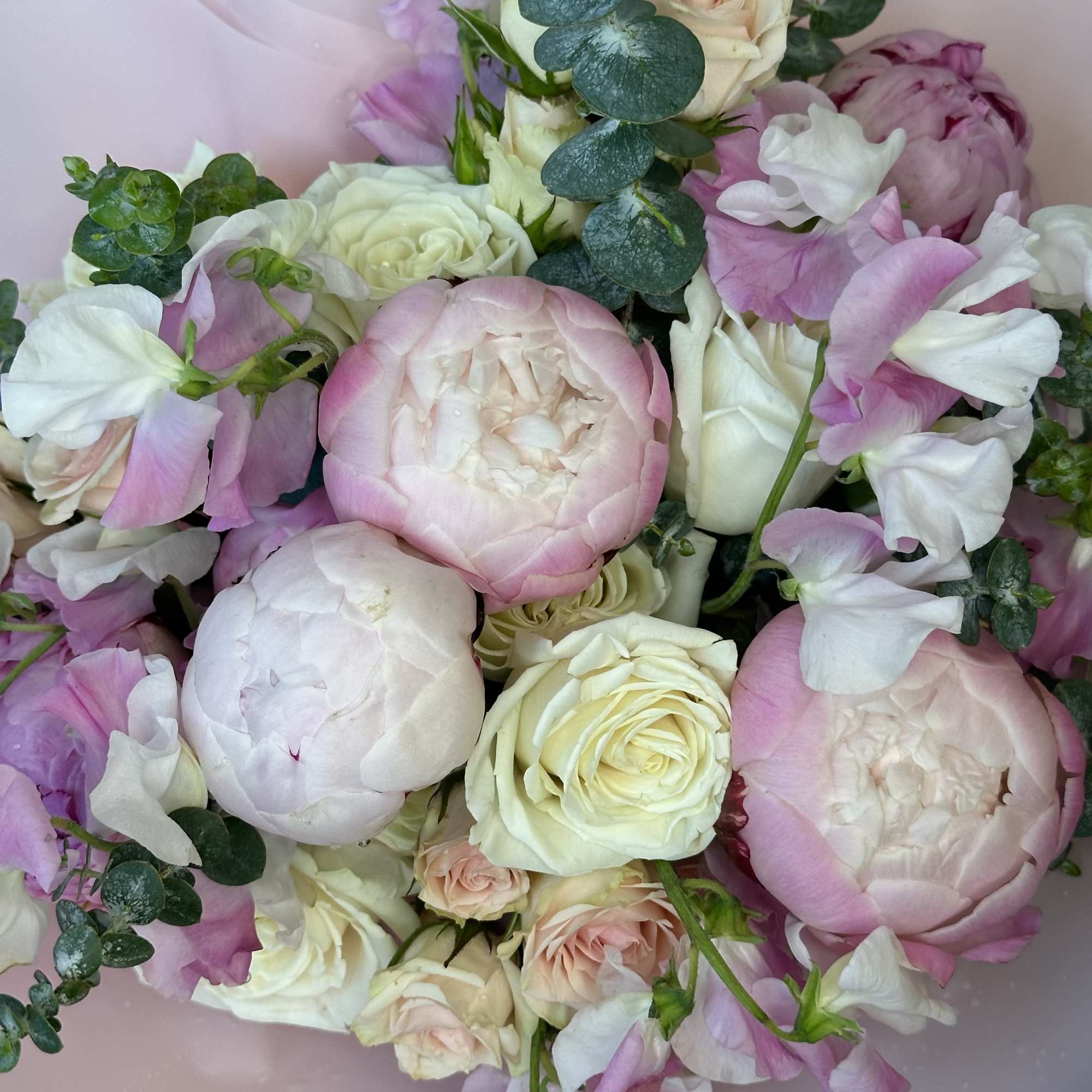 Pink and white bouquet with roses, peonies, and sweet peas