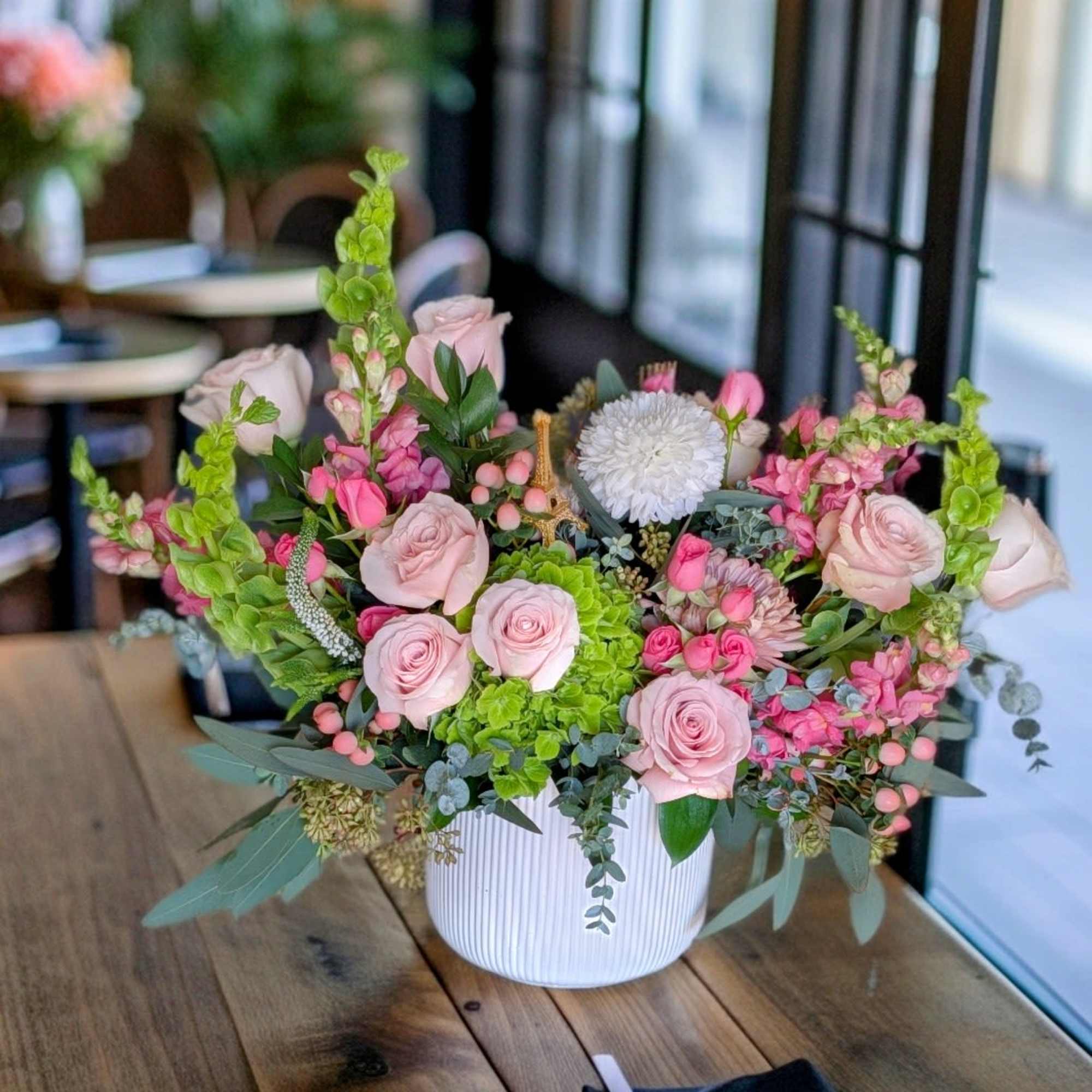 A garden style of soft blush, cream of seasonal flowers design in