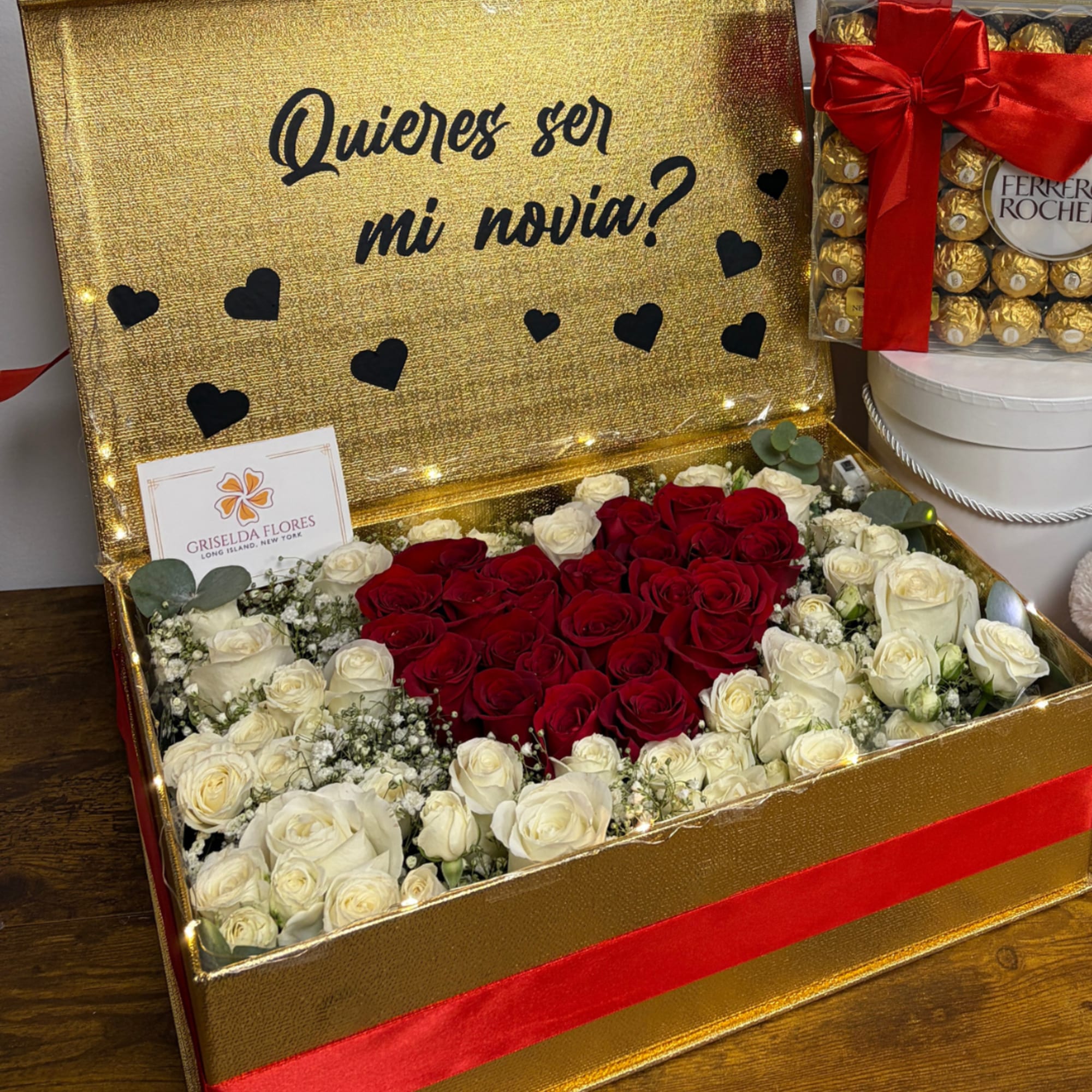 Gold gift box with red and white roses and a Ferrero Rocher box