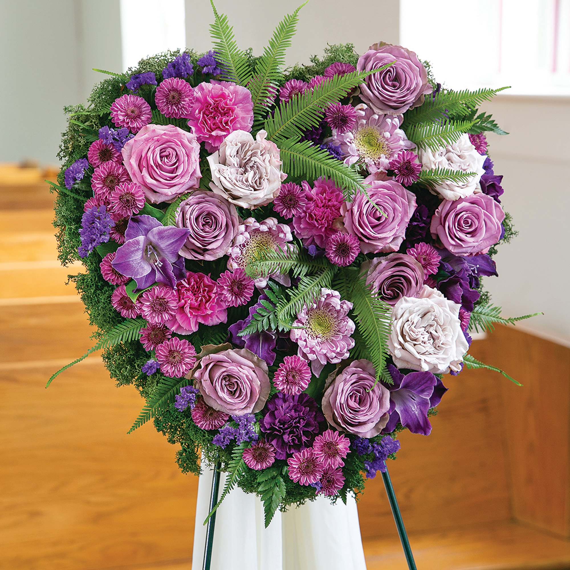 Purple and pink floral standing spray on an easel