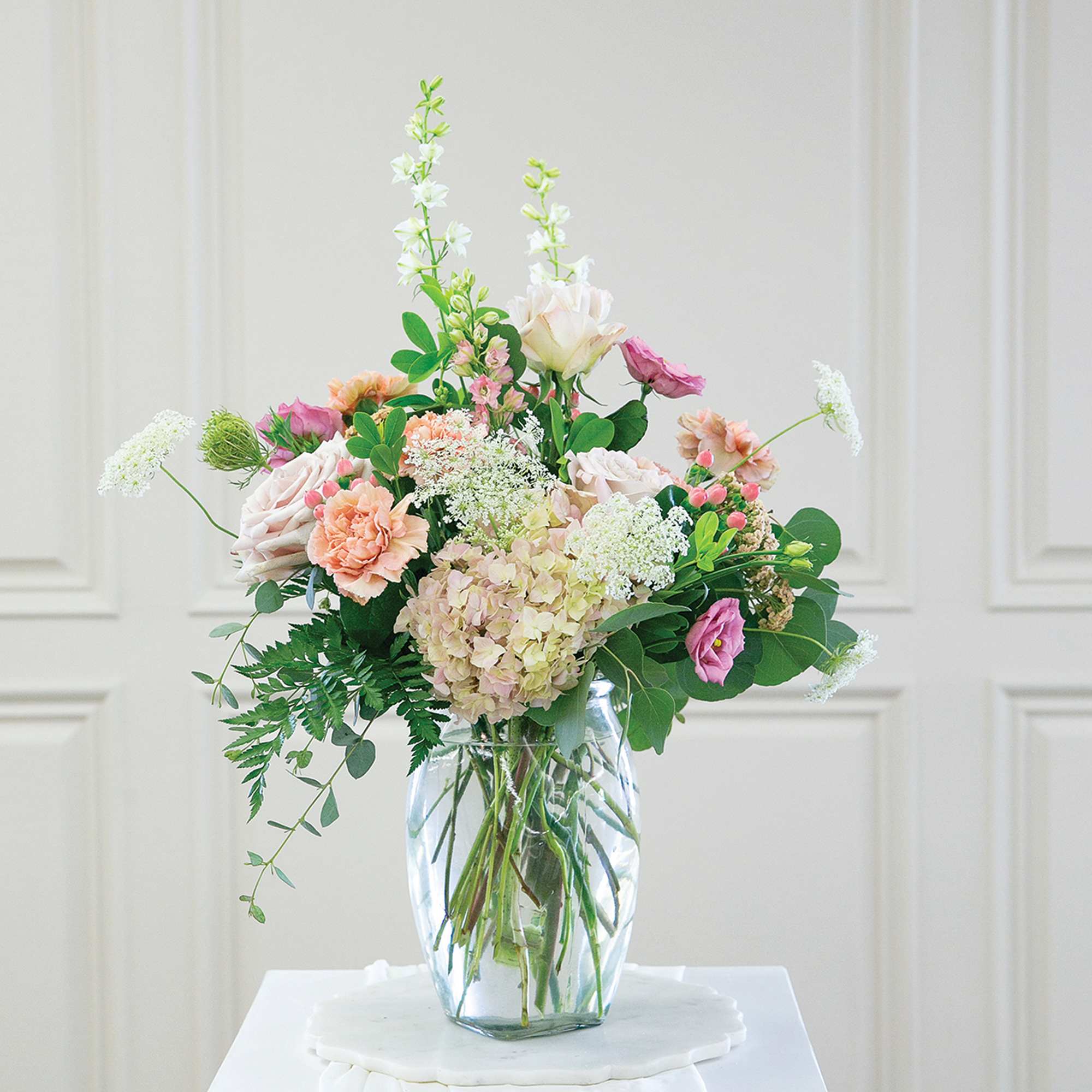 Pastel floral arrangement in a clear glass vase