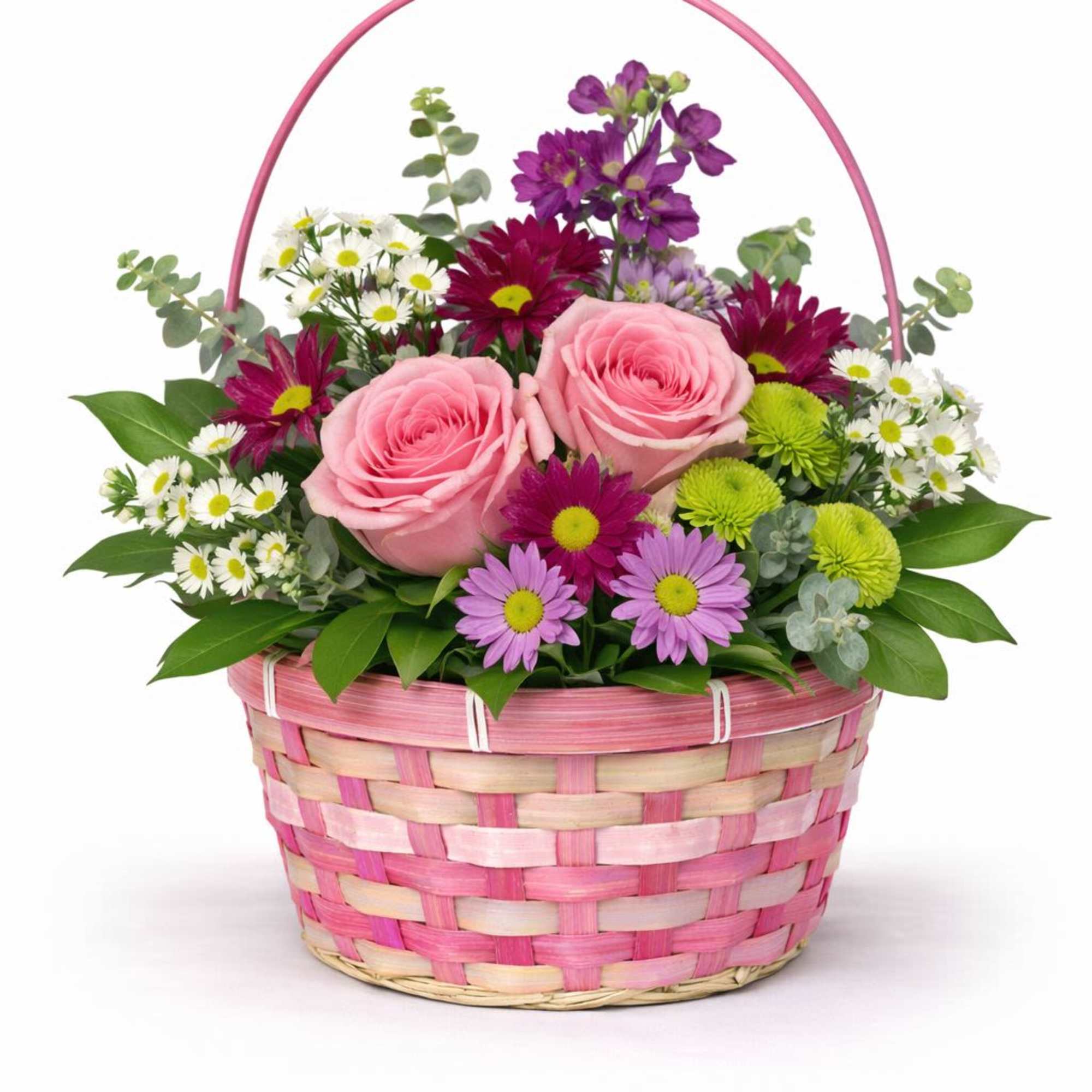 Pink roses and mixed daisies in a pink woven basket