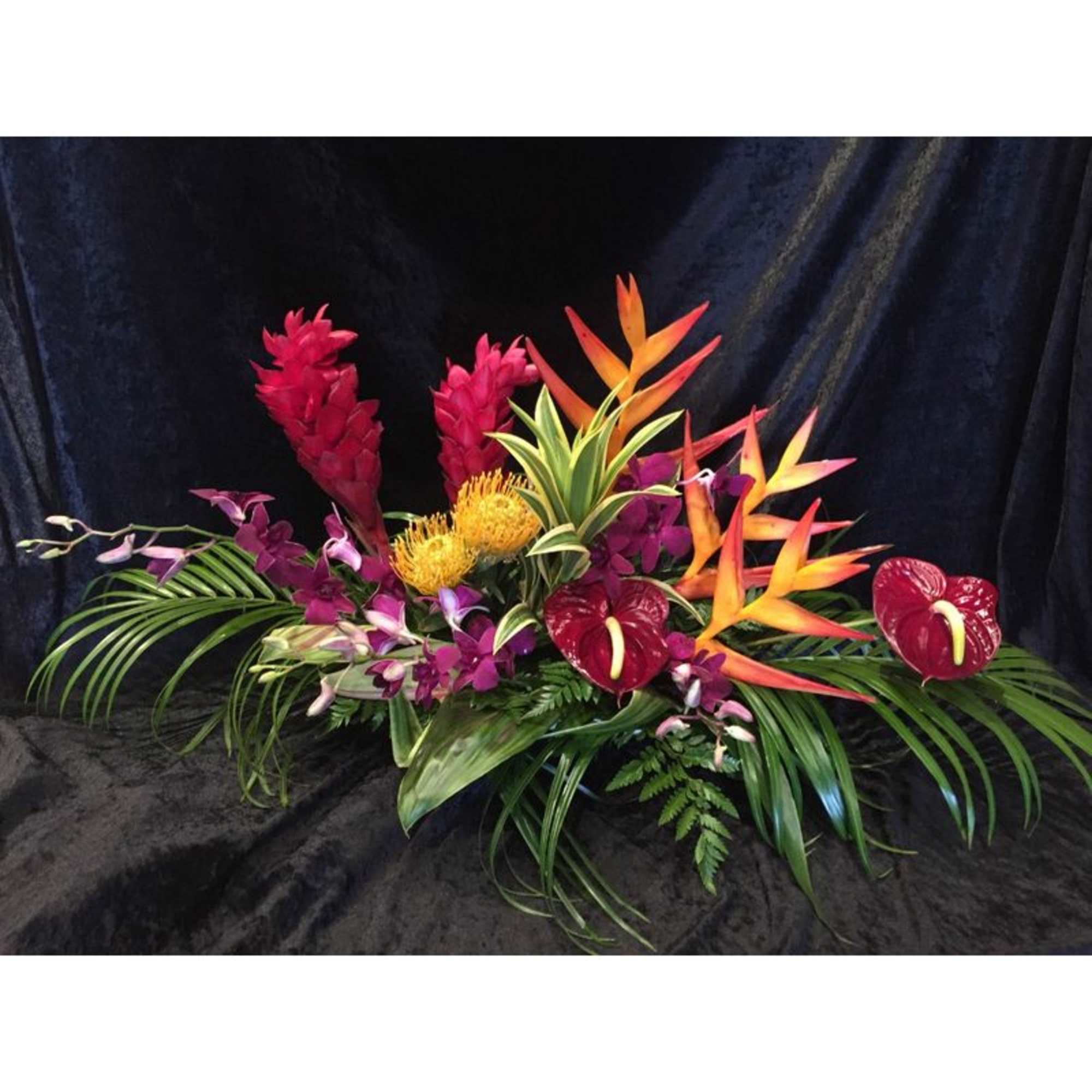 One  mixed tropical blooms and exotic foliage 
